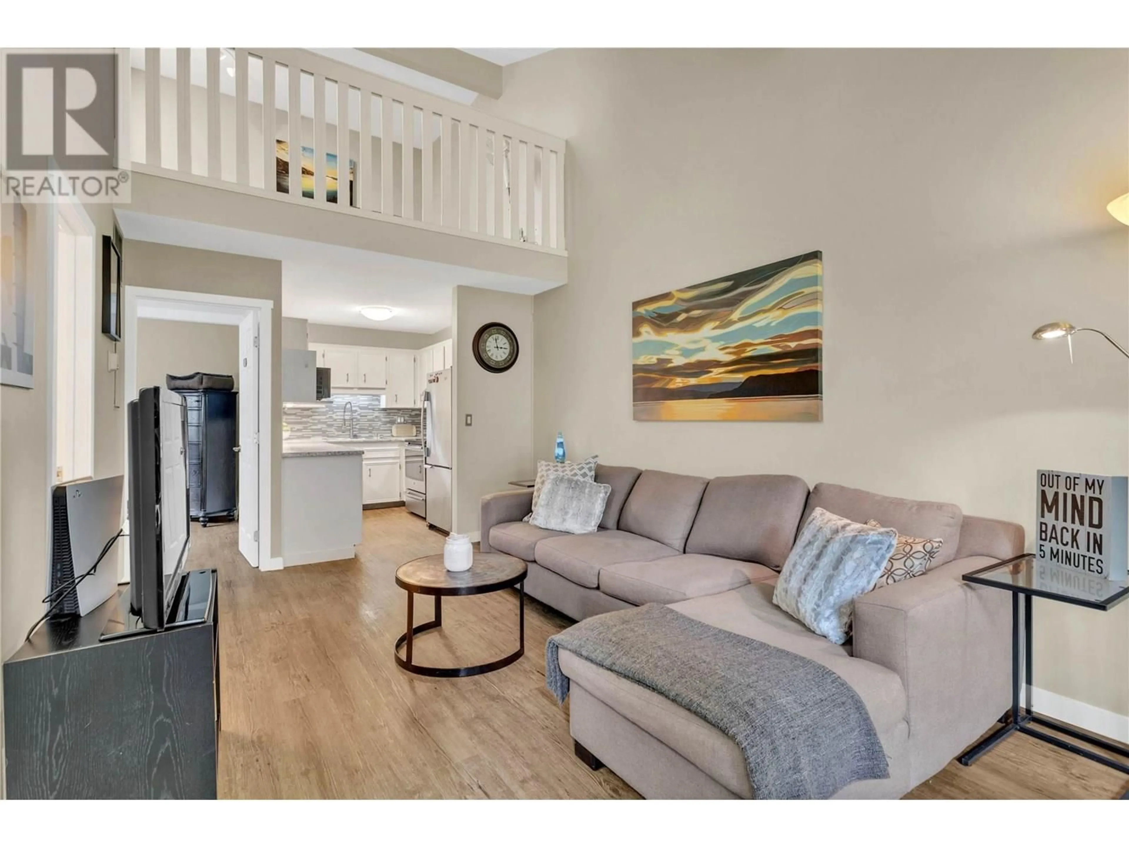 Living room with furniture, wood/laminate floor for 209 - 3155 GORDON DRIVE, Kelowna British Columbia V1W3N5