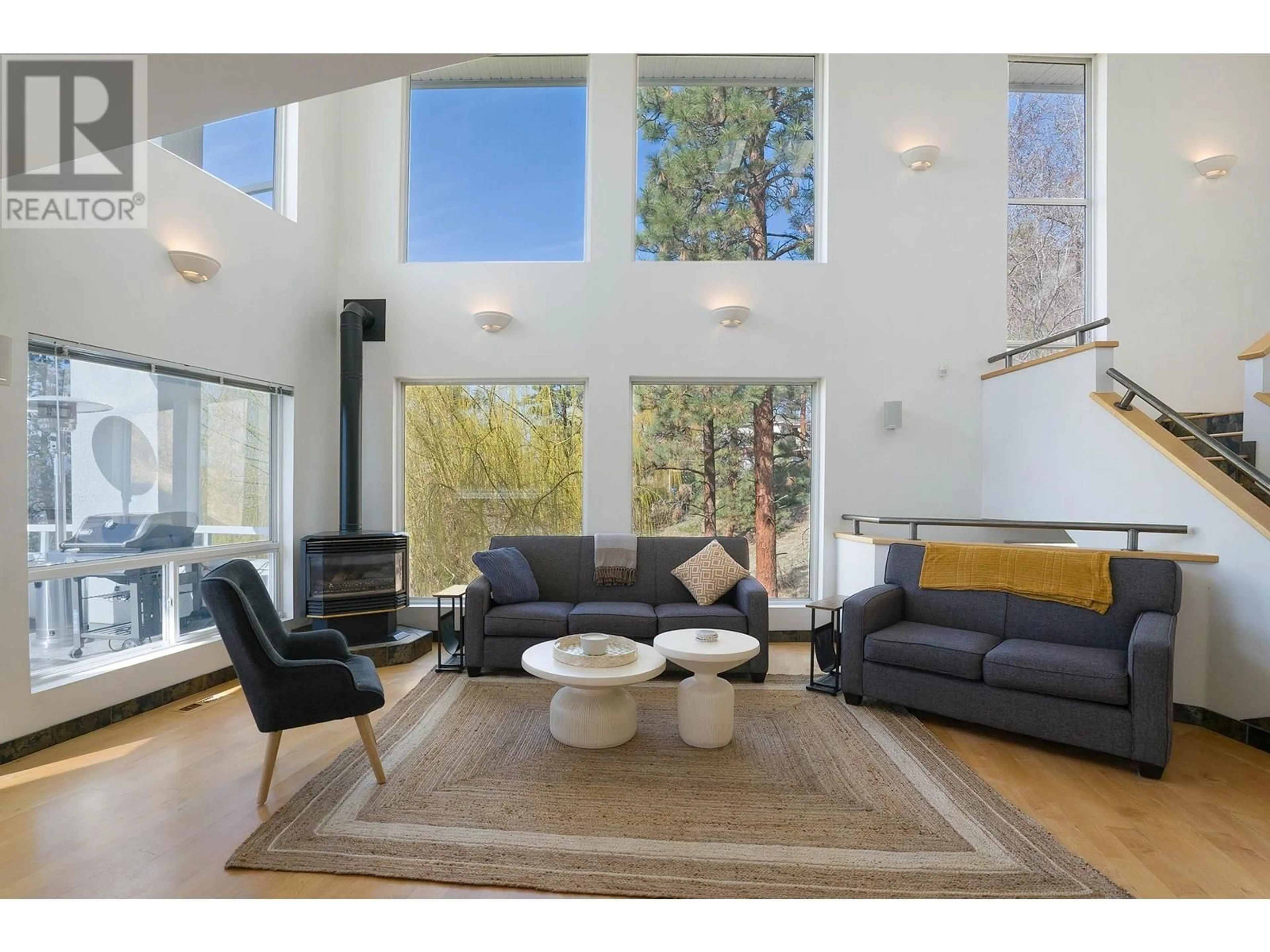 Living room with furniture, wood/laminate floor for 1022 JAMES HOCKEY PLACE, Kelowna British Columbia V1X7L2