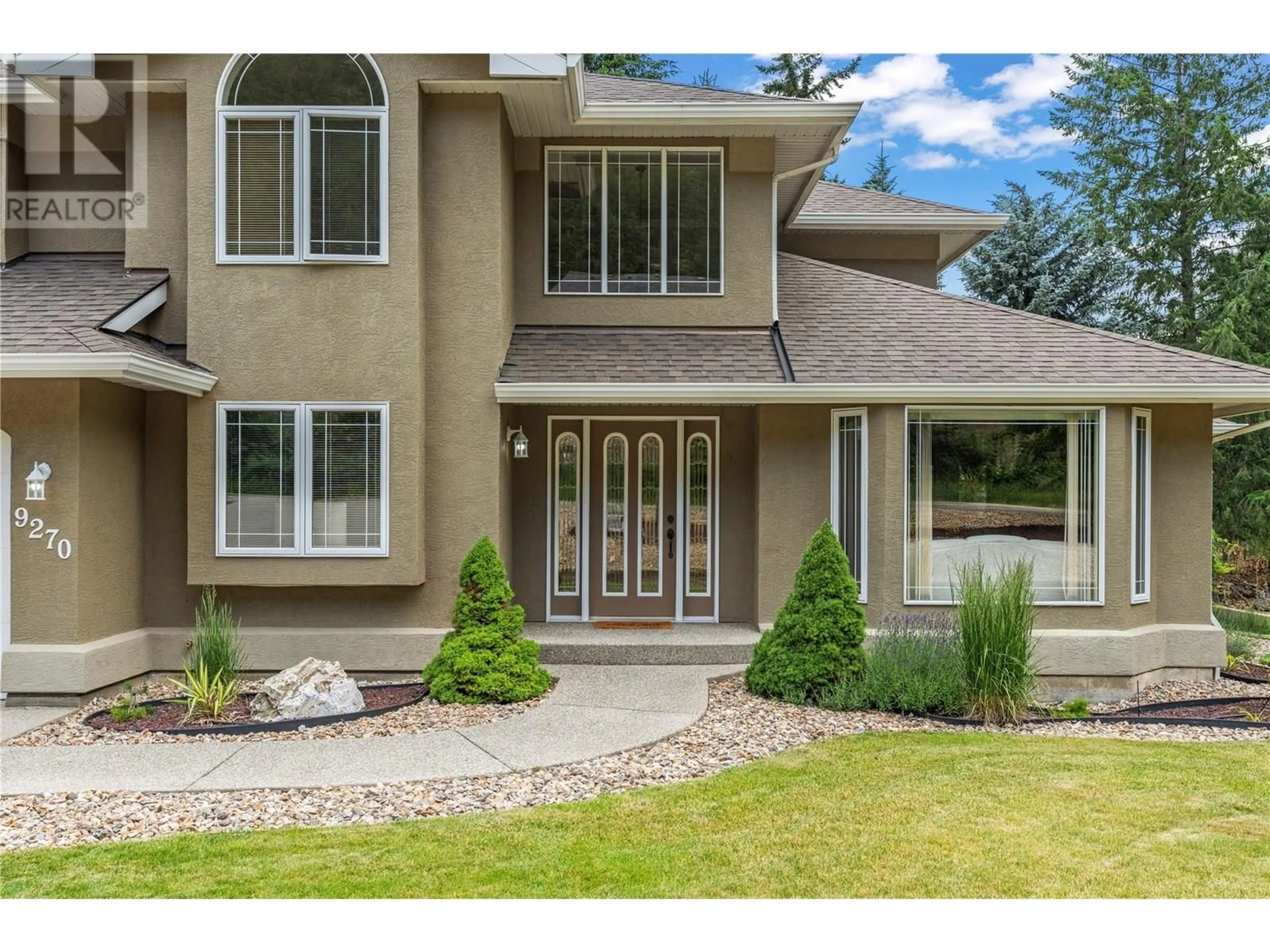 Home with vinyl exterior material, street for 9270 TRONSON ROAD, Vernon British Columbia V1H1E3