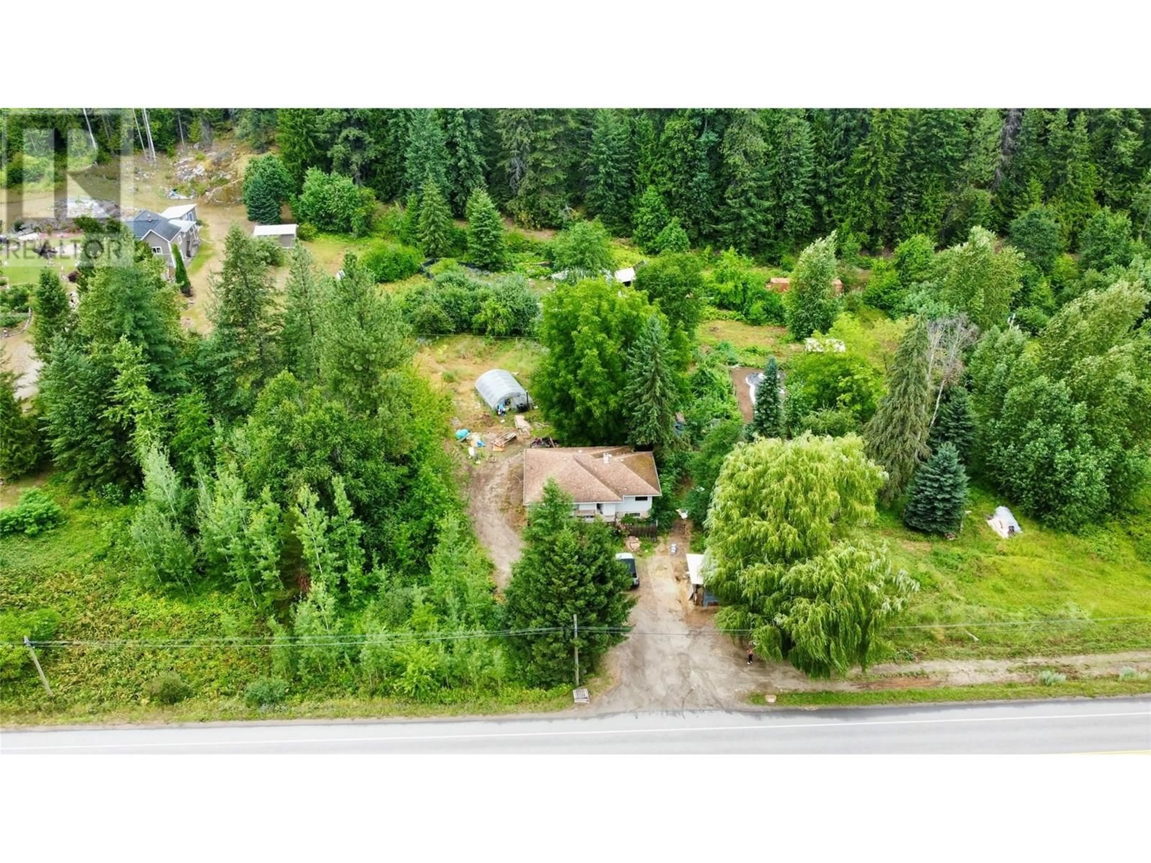 A pic from outside/outdoor area/front of a property/back of a property/a pic from drone, forest/trees view for 1765 HIGHWAY 3A HIGHWAY, Castlegar British Columbia V1N3H3