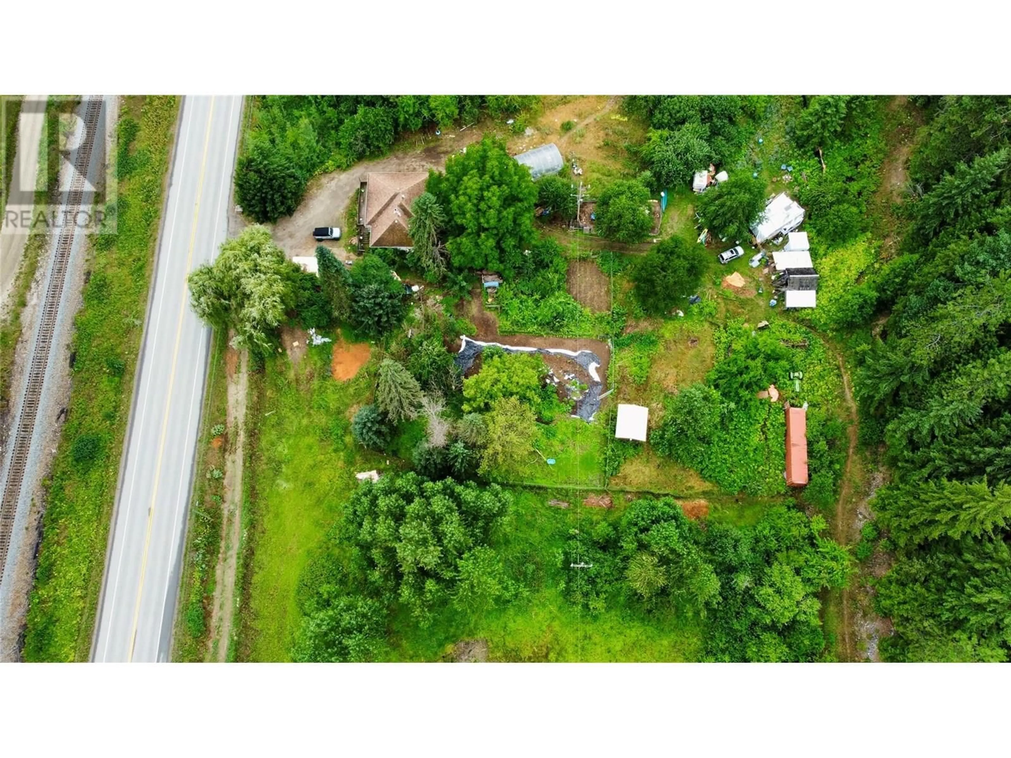 A pic from outside/outdoor area/front of a property/back of a property/a pic from drone, street for 1765 HIGHWAY 3A HIGHWAY, Castlegar British Columbia V1N3H3