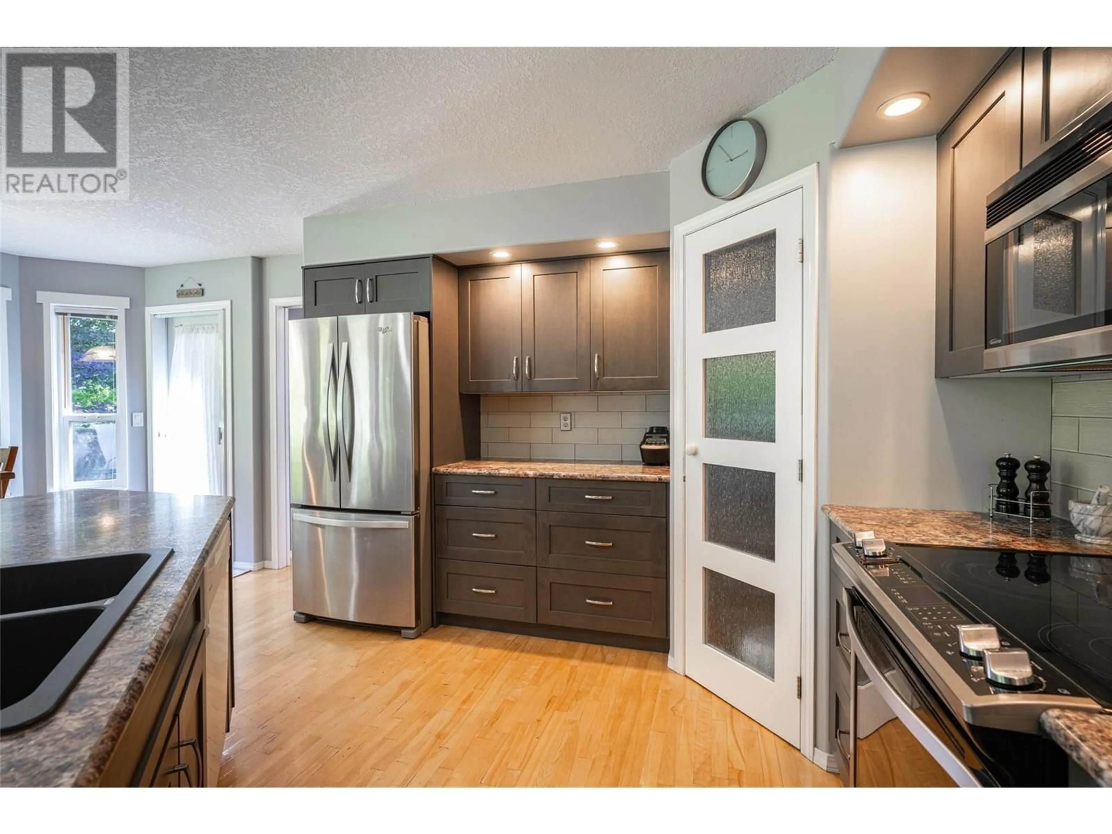 Open concept kitchen, wood/laminate floor for 947 MT. BEAVEN PLACE, Vernon British Columbia V1B2Y8