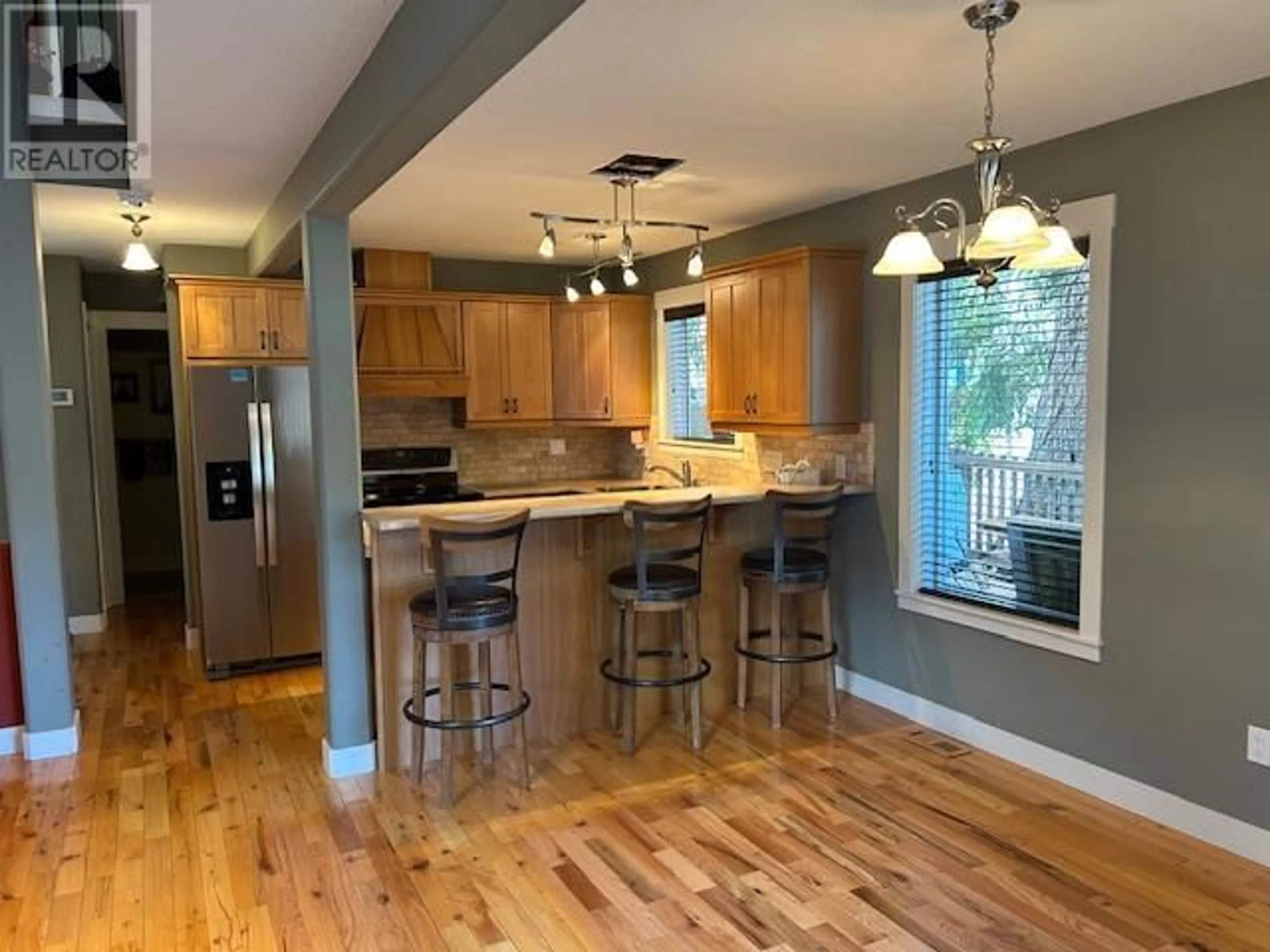Open concept kitchen, wood/laminate floor for 239 FALCON AVENUE, Vernon British Columbia V1H2A1
