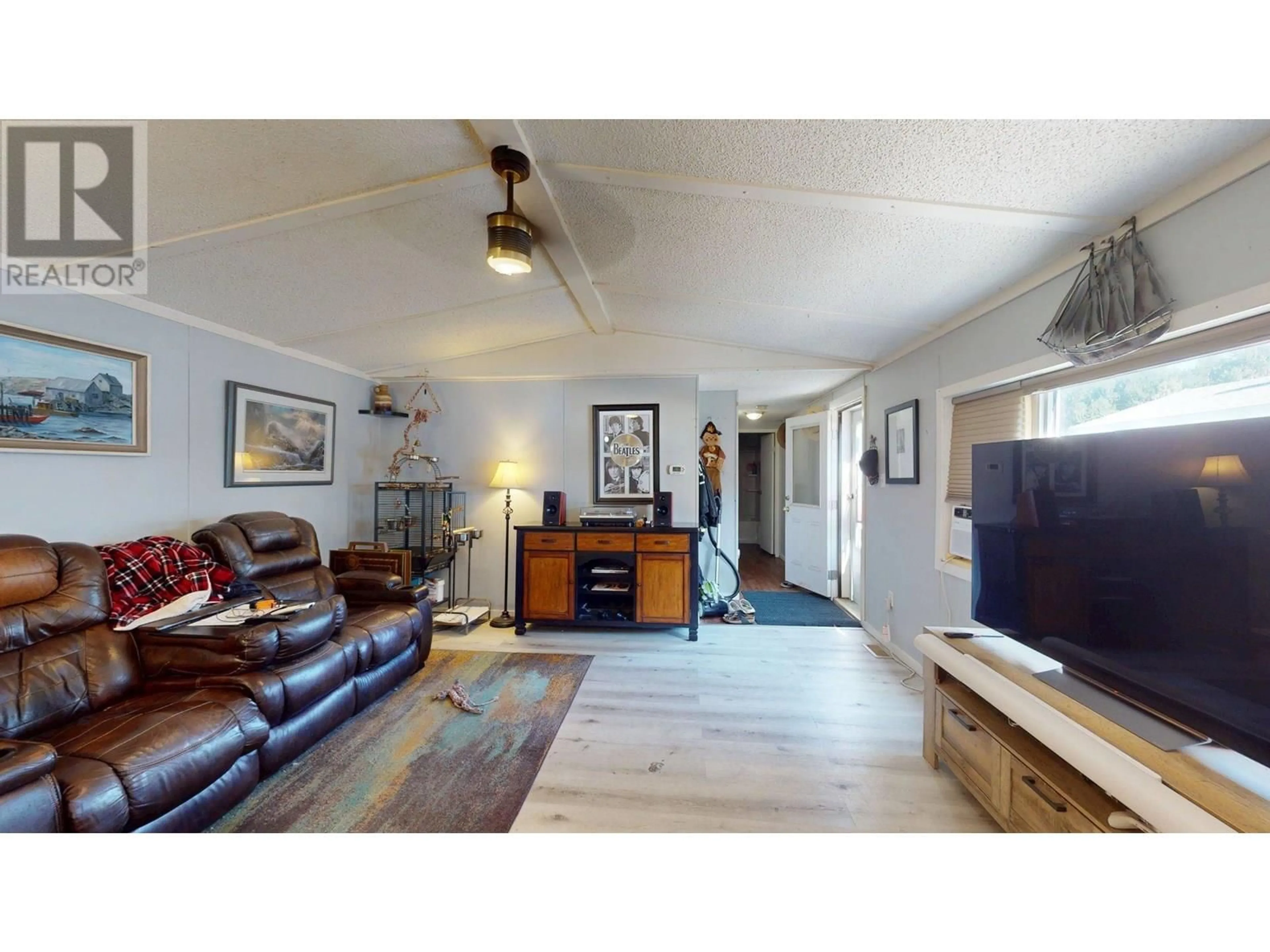 Living room with furniture, wood/laminate floor for 73 - 100 ASPEN DRIVE, Sparwood British Columbia V0B2G0