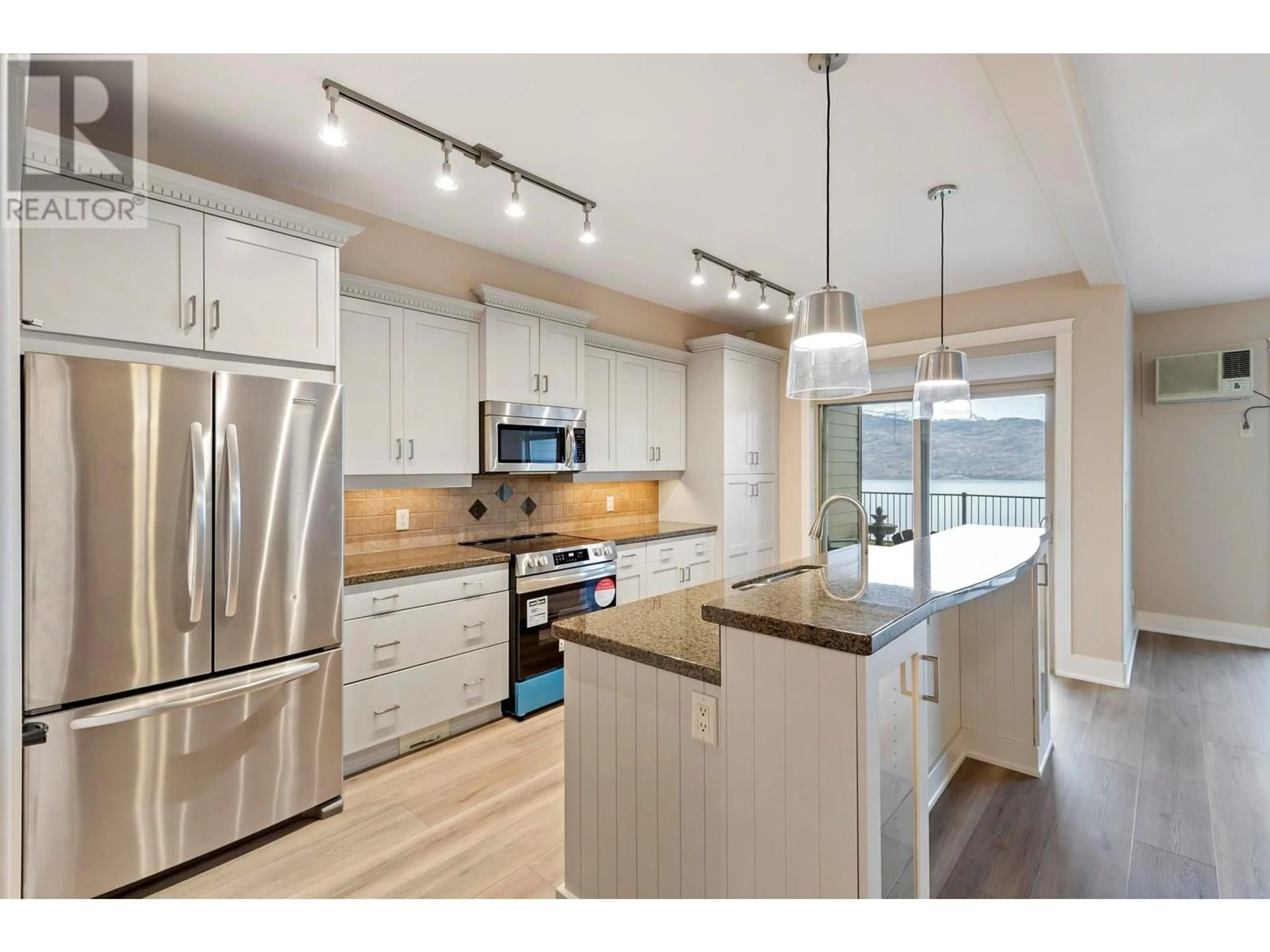 Open concept kitchen, wood/laminate floor for 114 - 4350 PONDEROSA DRIVE, Peachland British Columbia V0H1X5