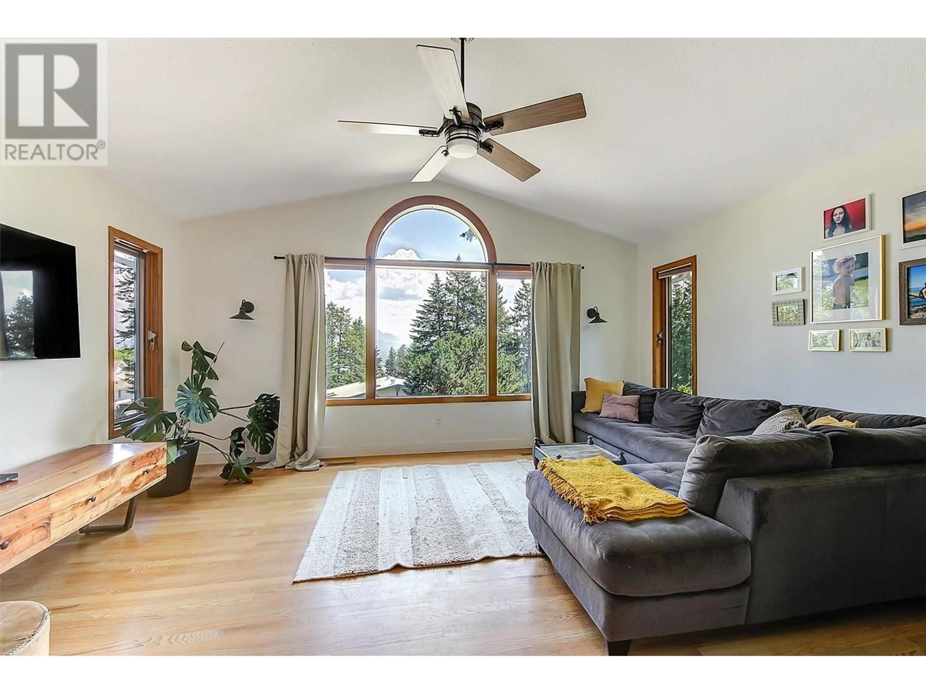Living room with furniture, wood/laminate floor for 1612 WEST KELOWNA ROAD, West Kelowna British Columbia V1Z3B7