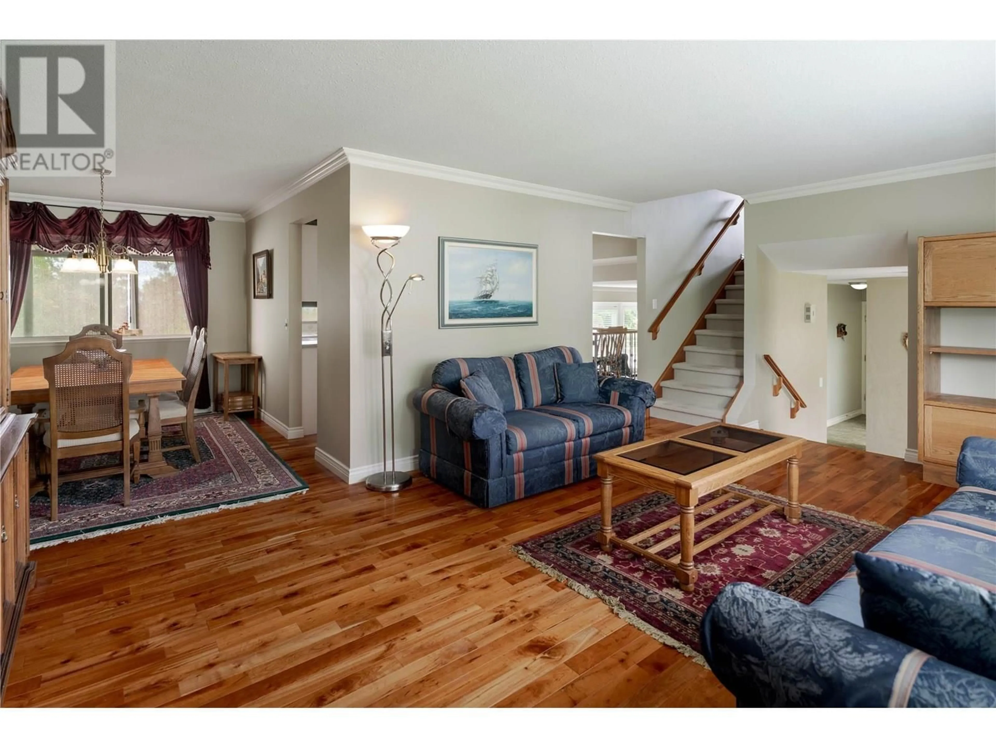 Living room with furniture, wood/laminate floor for 3942 SUNCREST COURT, Kelowna British Columbia V1W4E8