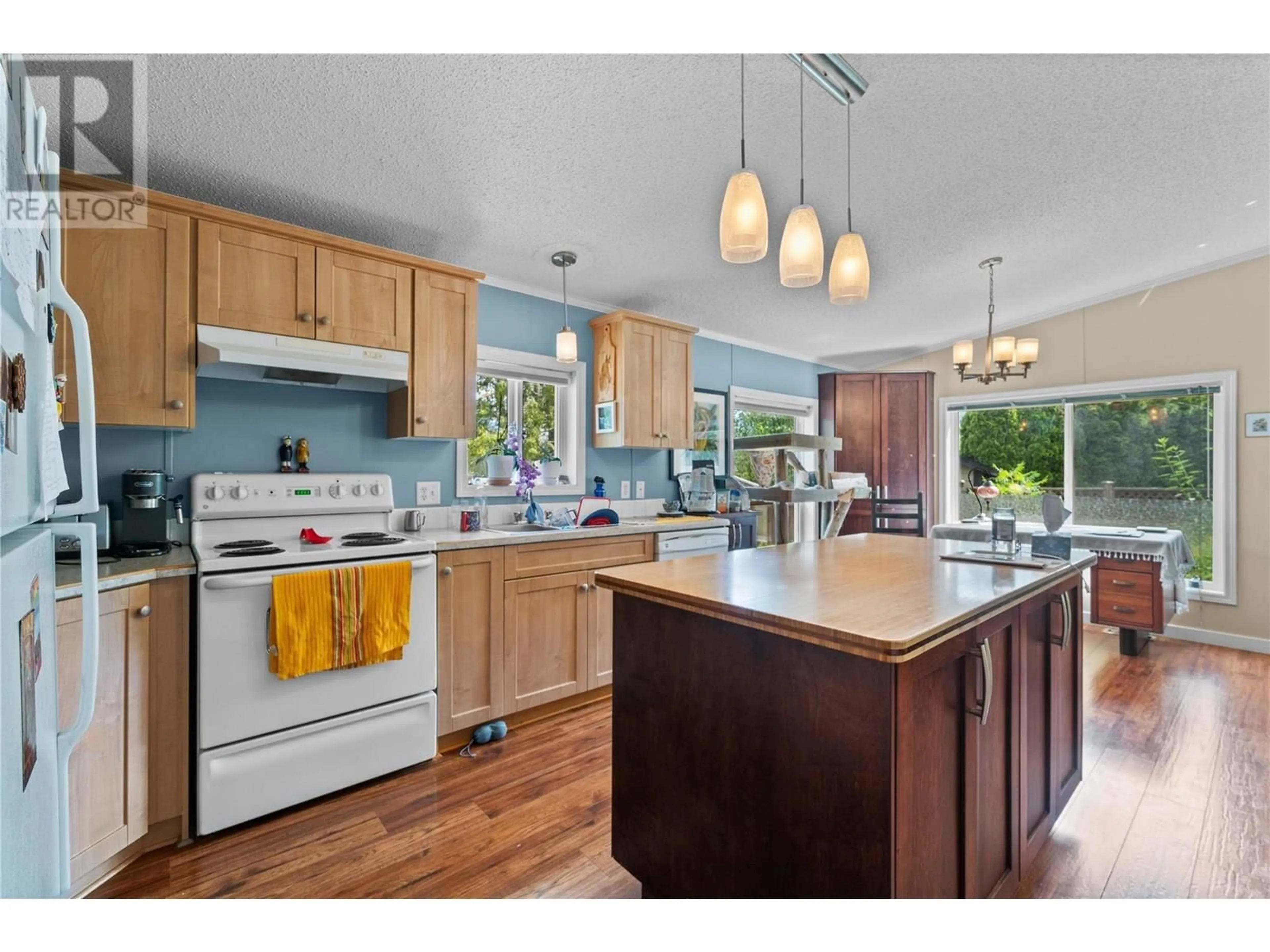 Open concept kitchen, wood/laminate floor for 4421 73 AVENUE NORTHEAST, Salmon Arm British Columbia V0E1K0