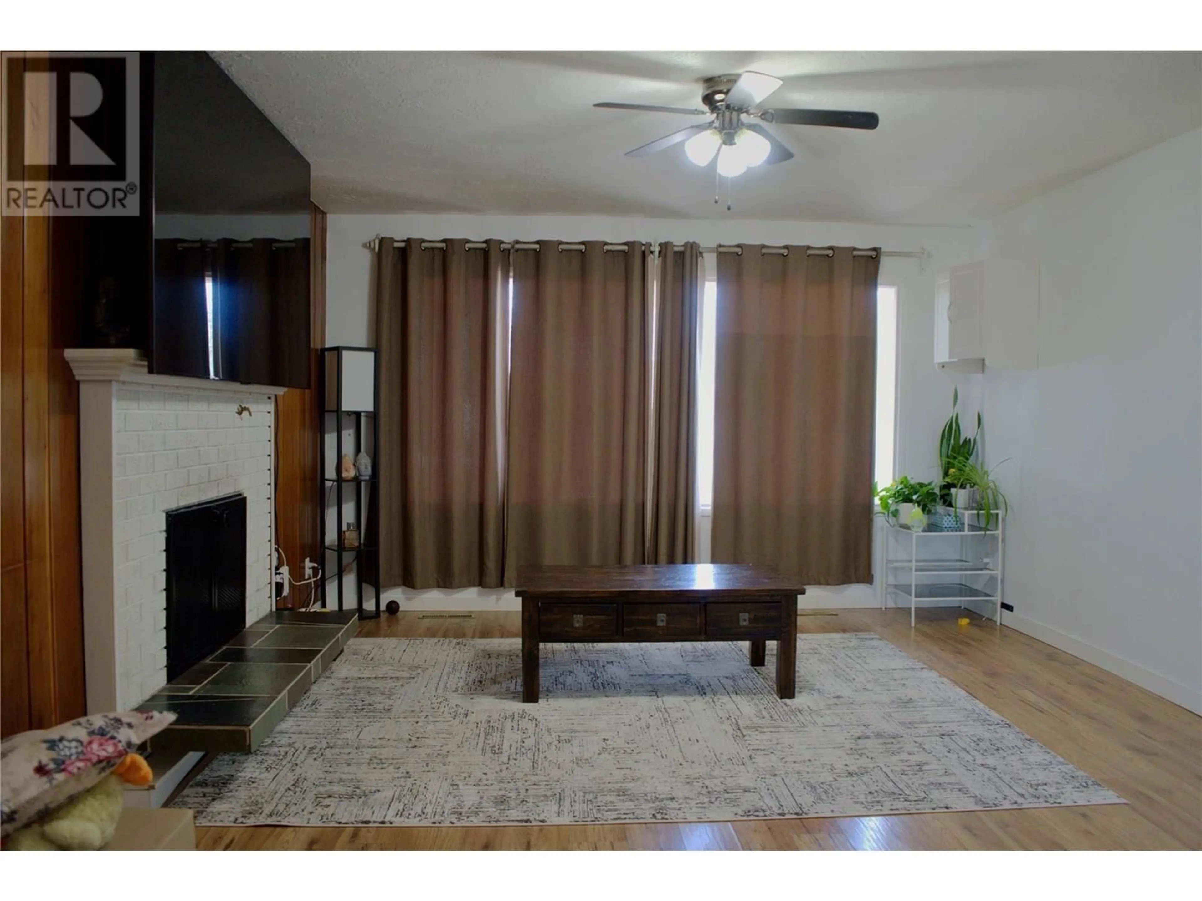 Living room with furniture, wood/laminate floor for 873 107 AVENUE, Dawson Creek British Columbia V1G2R3