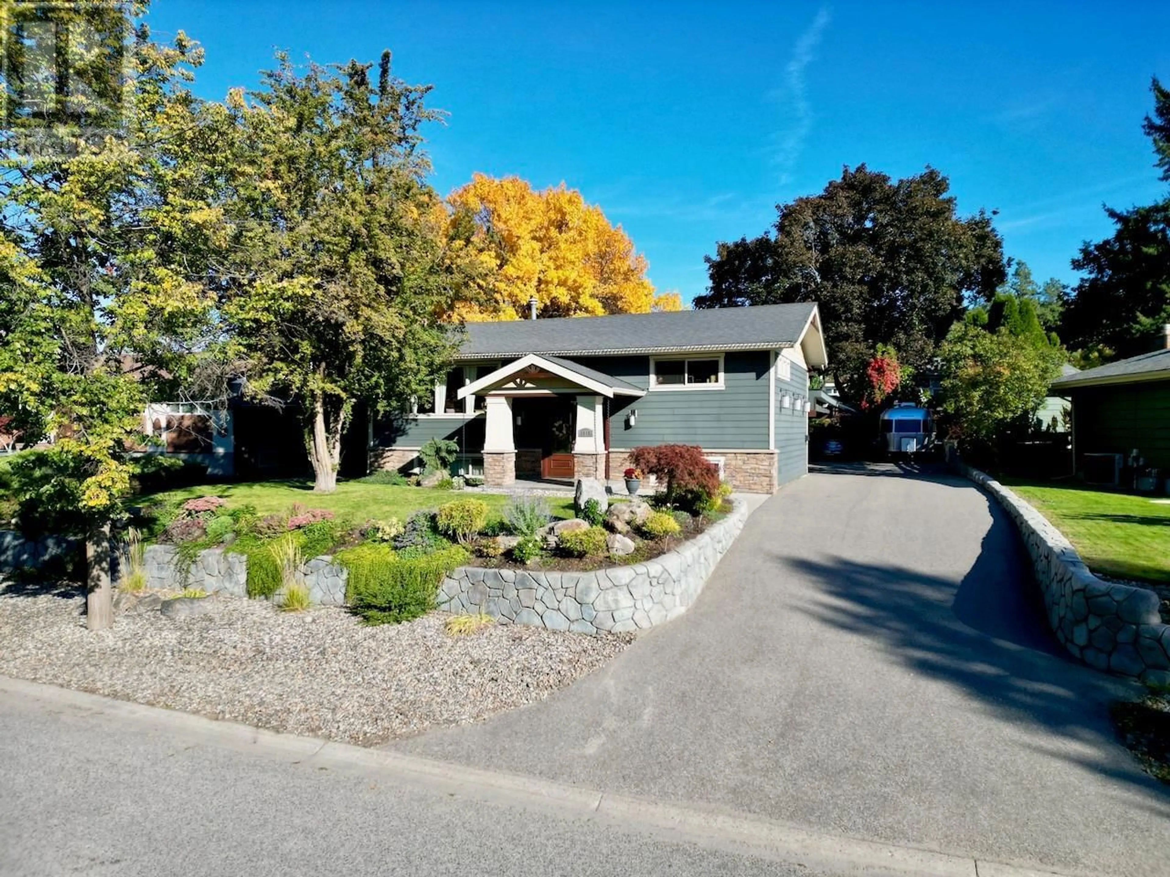 Home with vinyl exterior material, street for 1115 PINECREST LANE, Kelowna British Columbia V1Y4L4