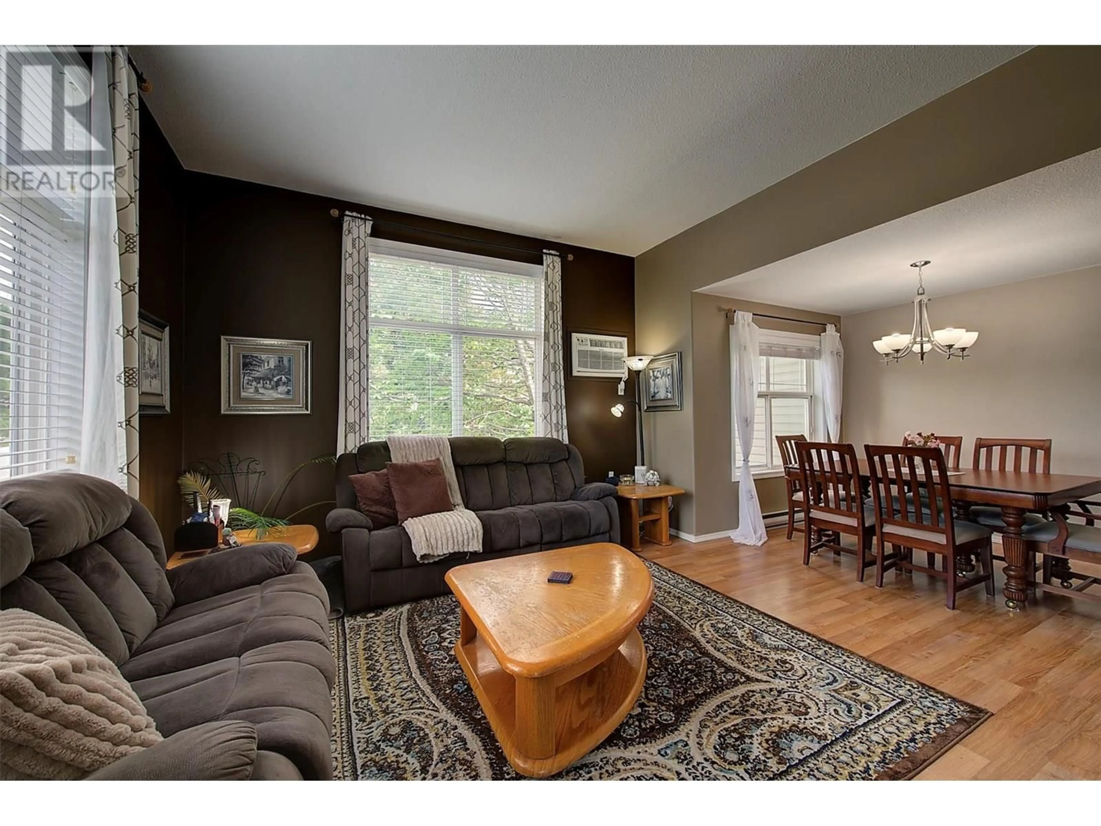 Living room with furniture, wood/laminate floor for 203 - 555 HOUGHTON ROAD, Kelowna British Columbia V1X7P9