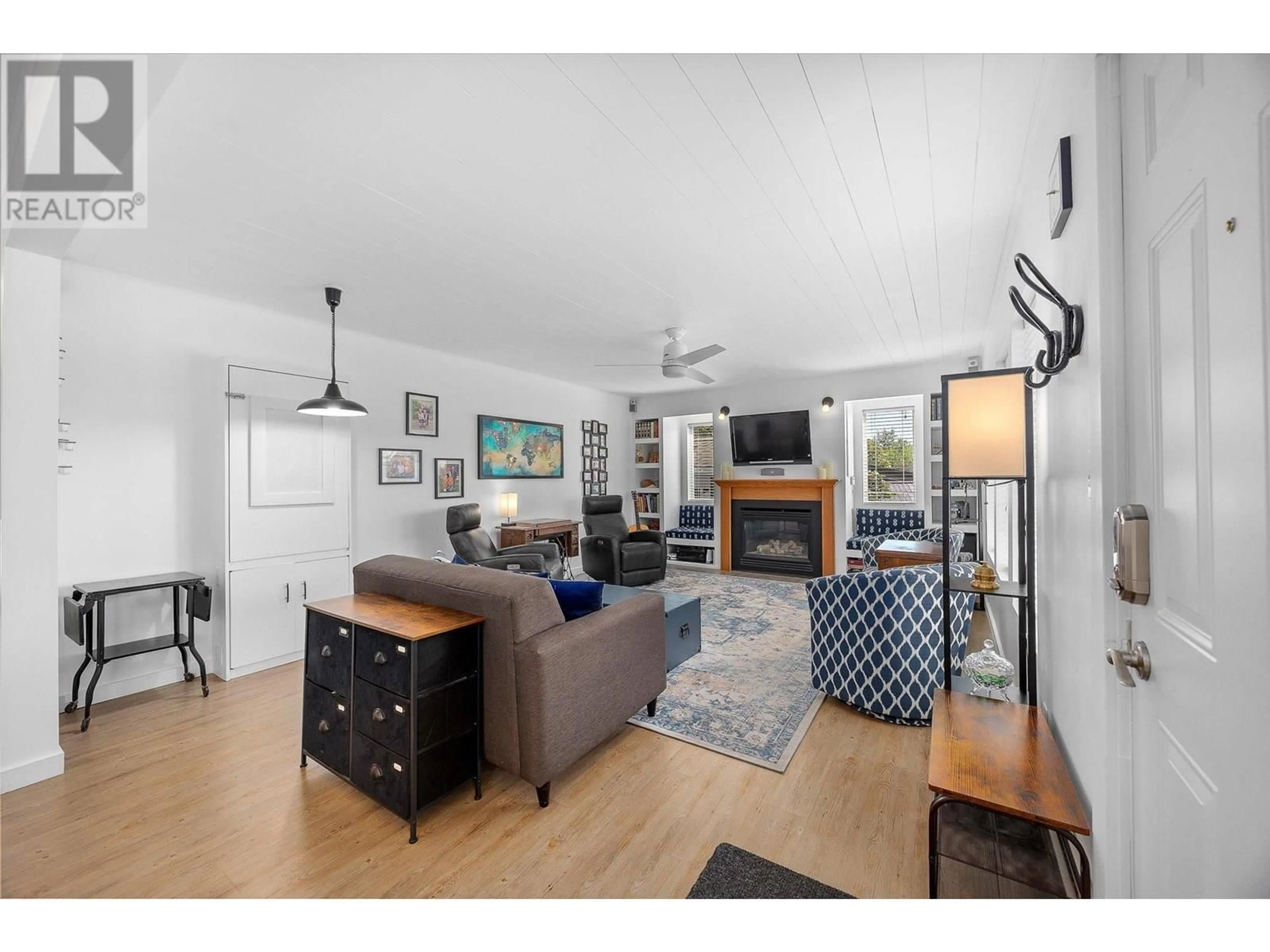 Living room with furniture, wood/laminate floor for 1575 HIGH ROAD, Kelowna British Columbia V1Y7B7