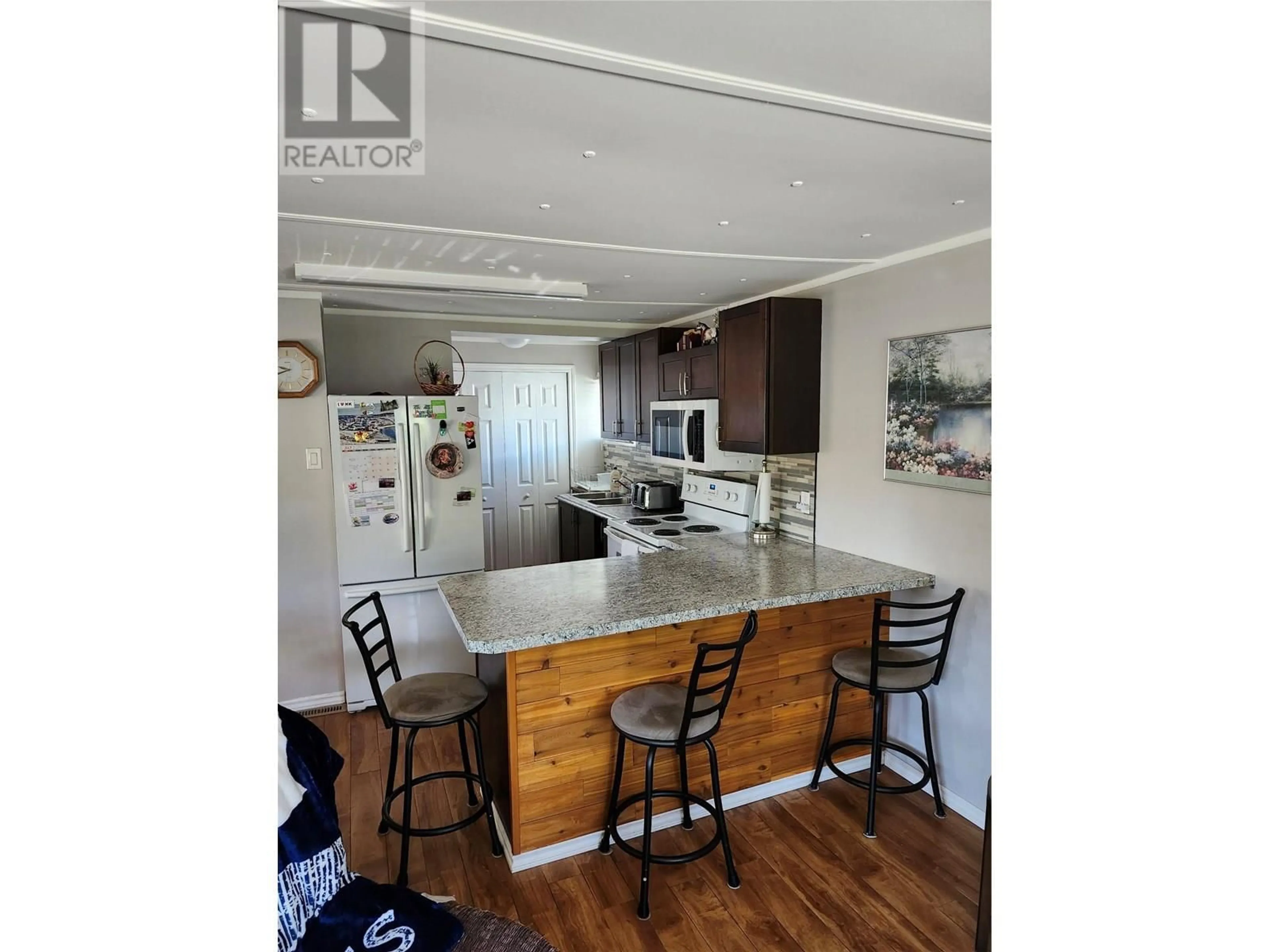 Open concept kitchen, wood/laminate floor for 27 - 8712 STEUART STREET, Summerland British Columbia V0H1Z6
