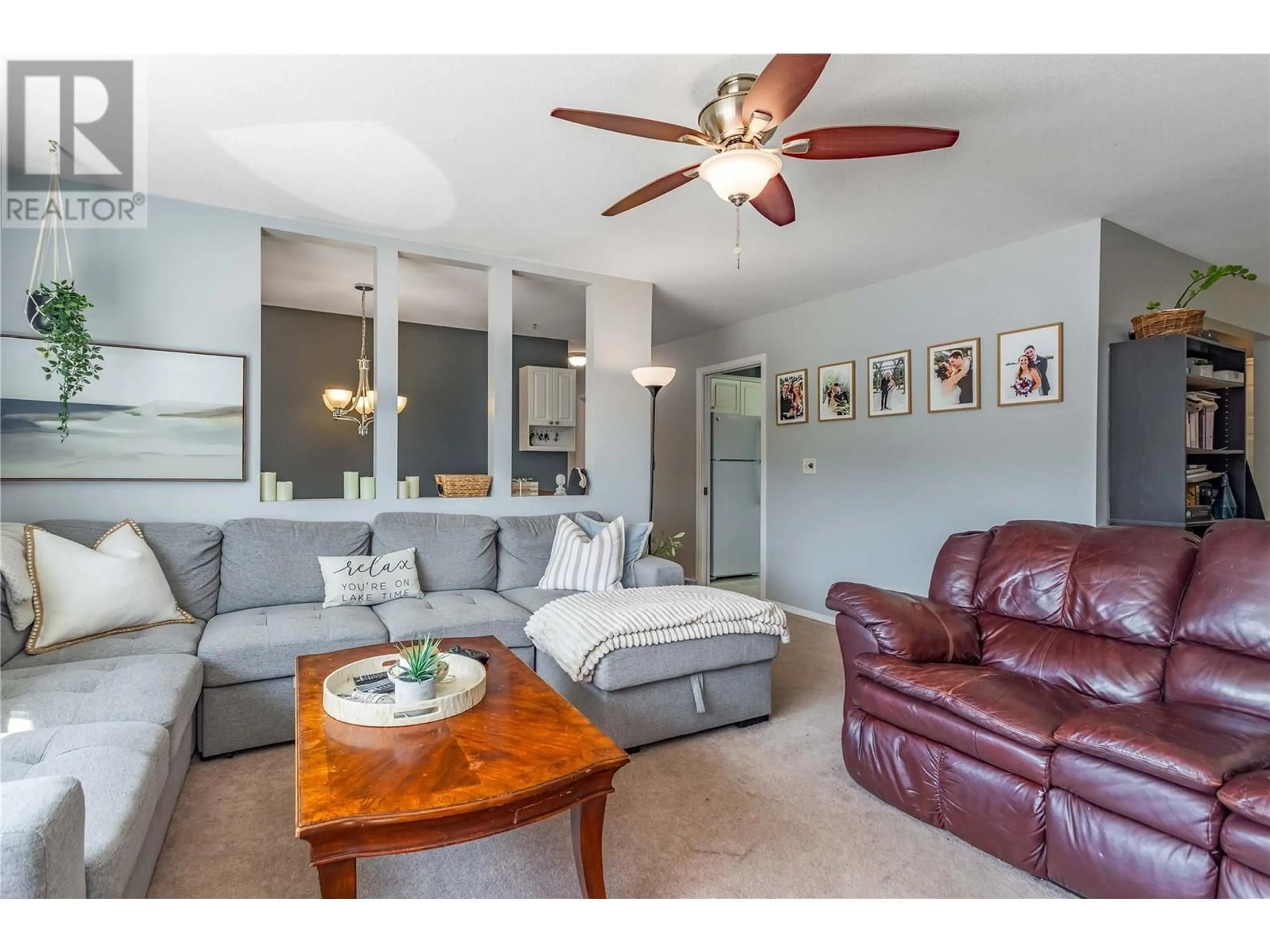 Living room with furniture, wood/laminate floor for 430 MOLNAR ROAD, Kelowna British Columbia V1X5H6