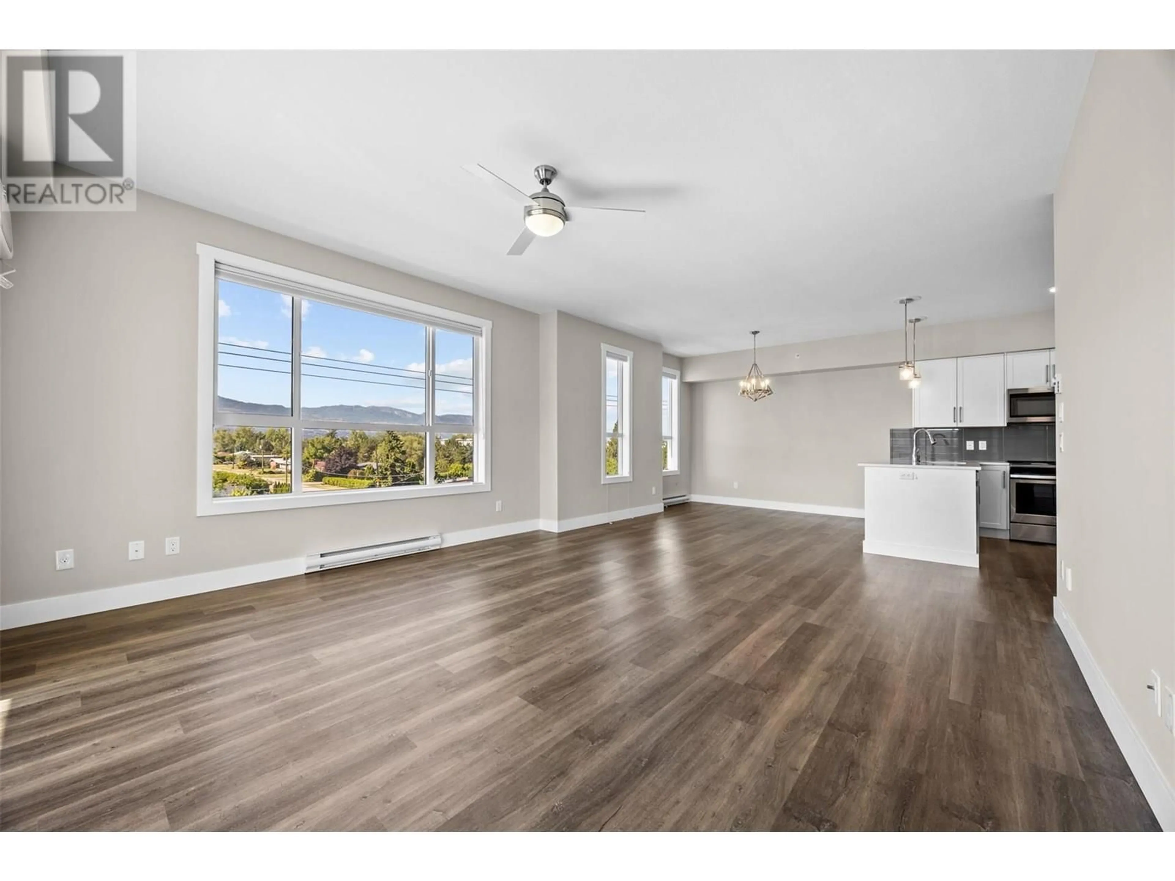 Open concept kitchen, wood/laminate floor for 313 - 3090 BURTCH ROAD, Kelowna British Columbia V1W5G9