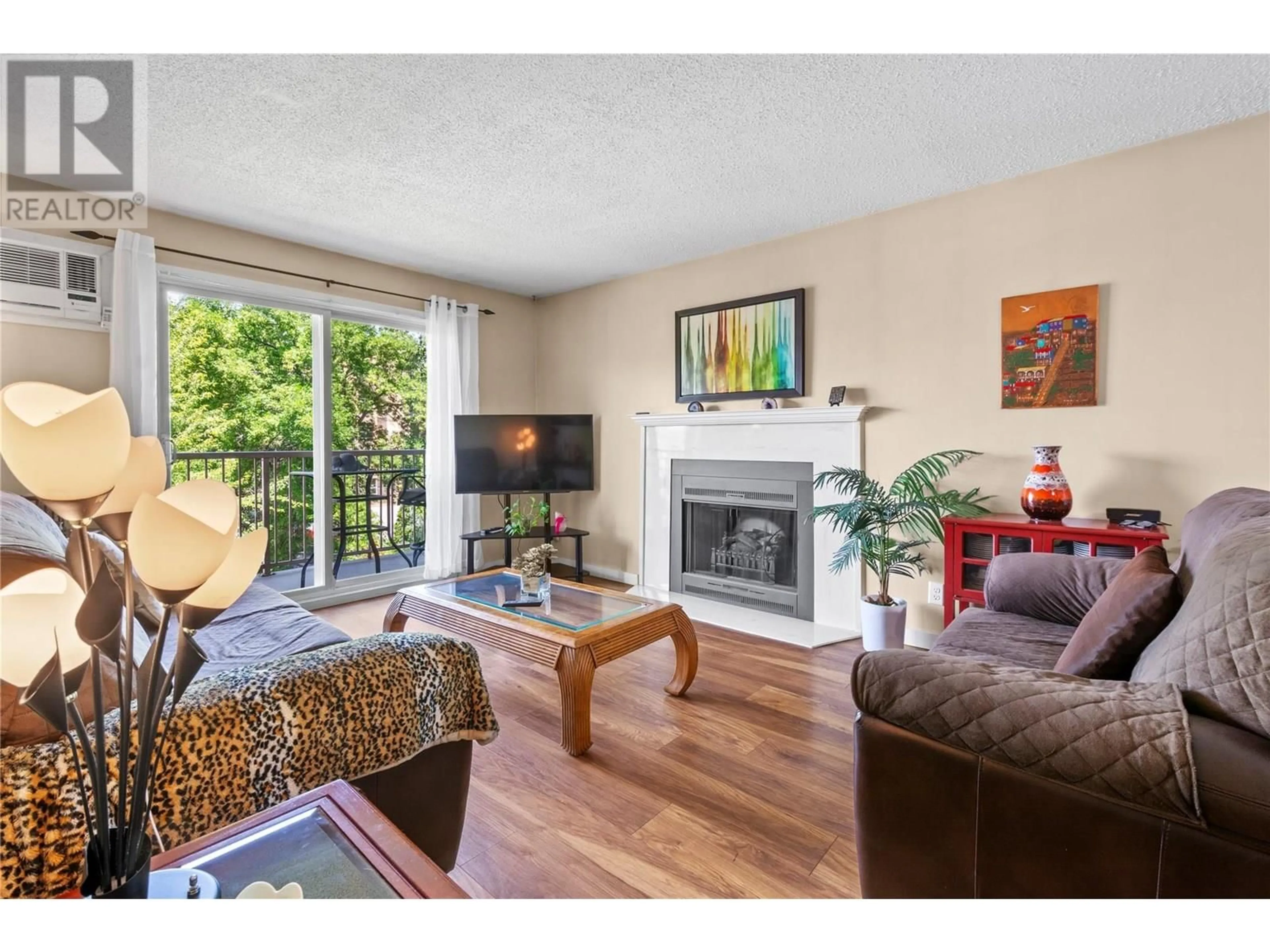 Living room with furniture, wood/laminate floor for 312 - 130 SKAHA PLACE, Penticton British Columbia V2A7J6