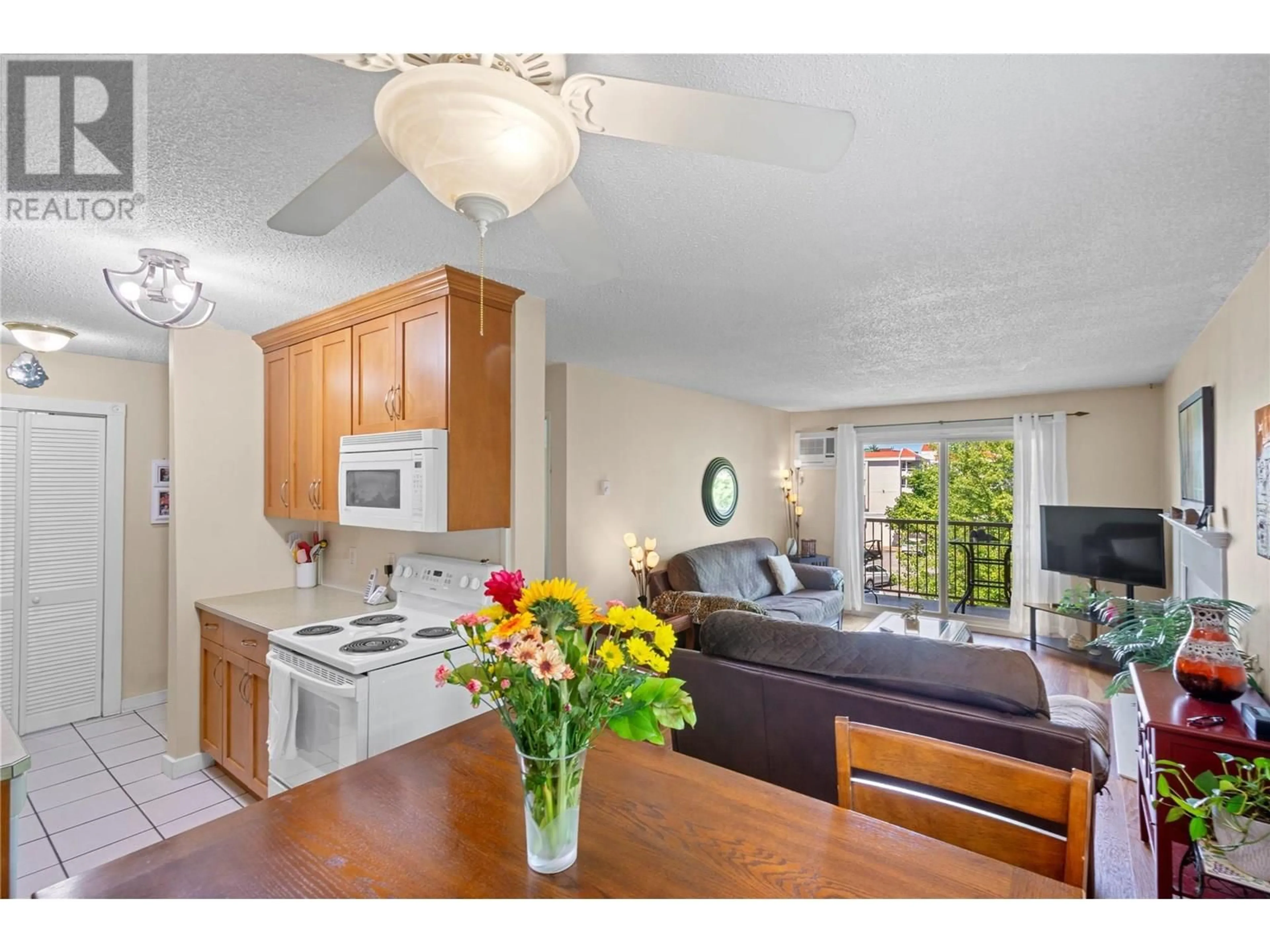 Open concept kitchen, wood/laminate floor for 312 - 130 SKAHA PLACE, Penticton British Columbia V2A7J6