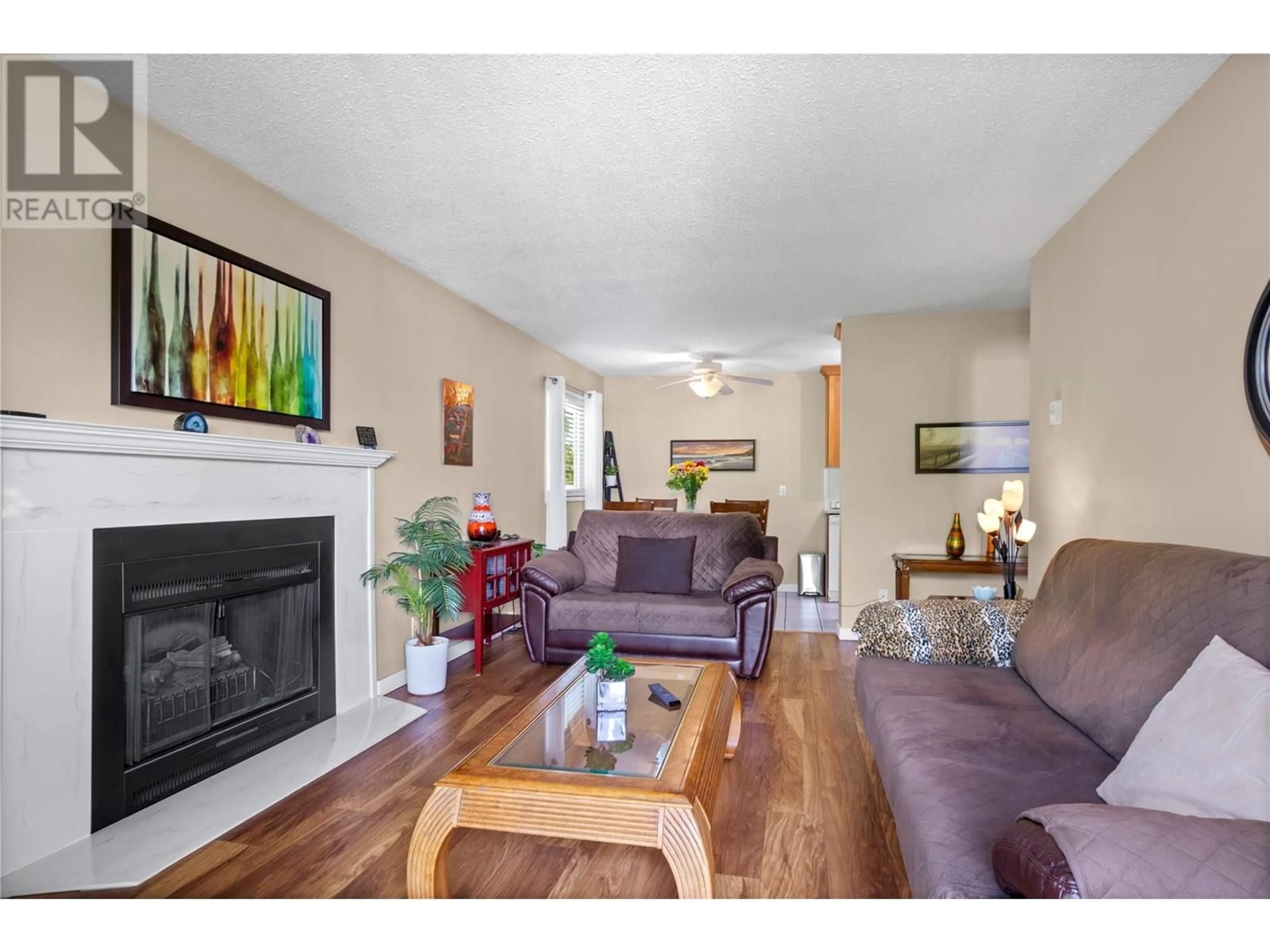 Living room with furniture, wood/laminate floor for 312 - 130 SKAHA PLACE, Penticton British Columbia V2A7J6