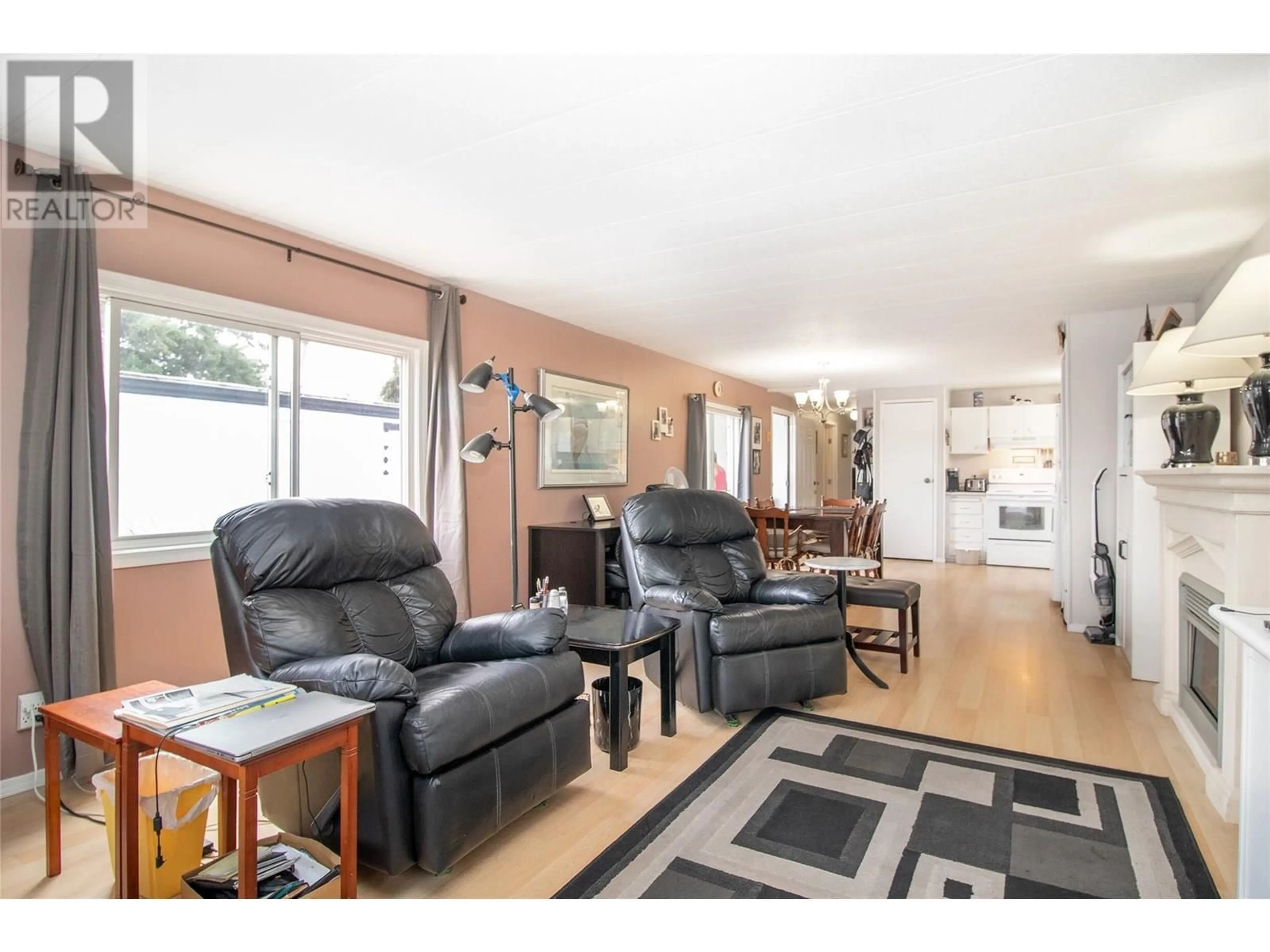 Living room with furniture, wood/laminate floor for 71 - 3745 LAKESHORE ROAD, Kelowna British Columbia V1W3K4