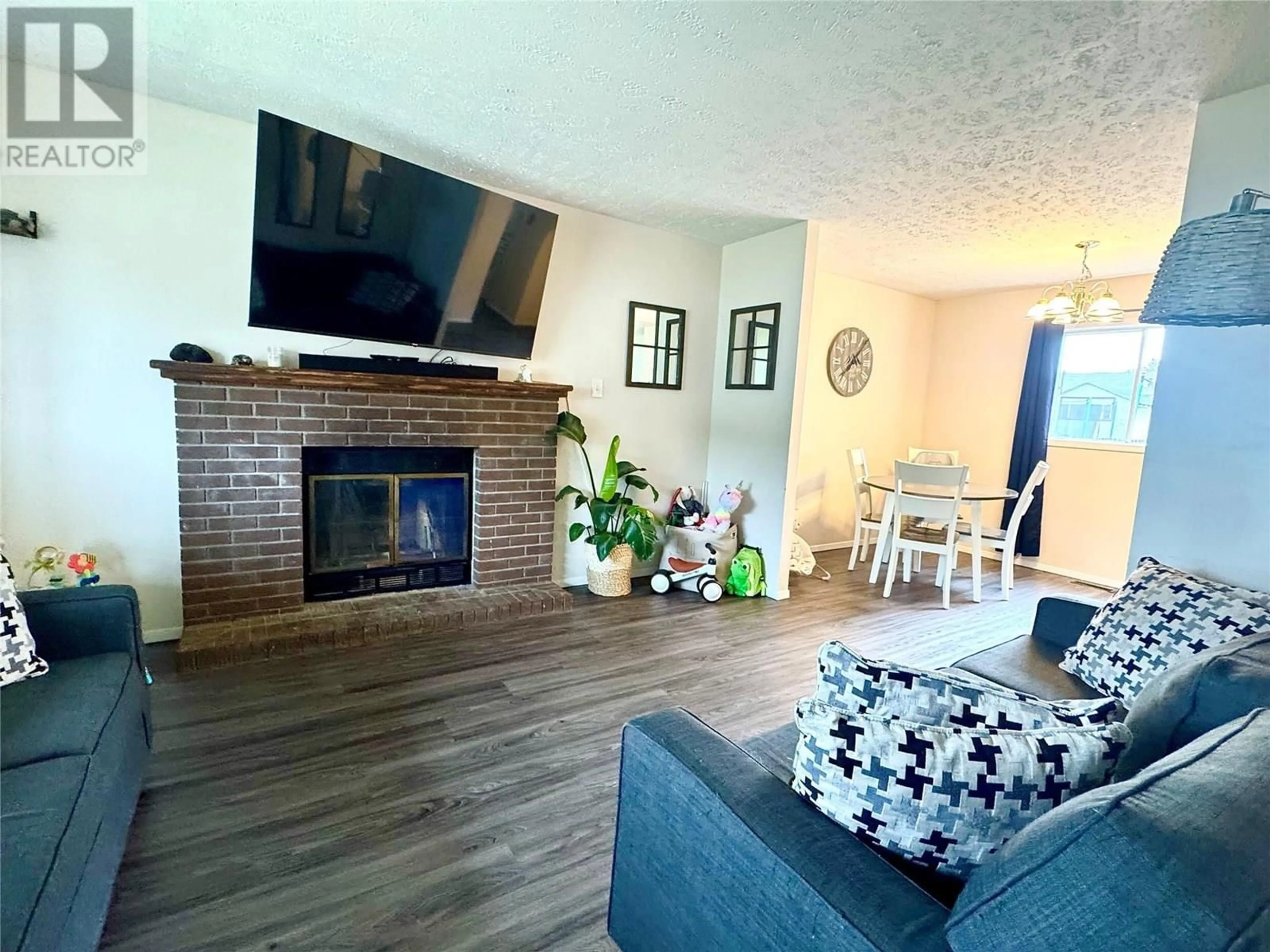 Living room with furniture, wood/laminate floor for 128 FELLERS AVENUE, Tumbler Ridge British Columbia V0C2W0