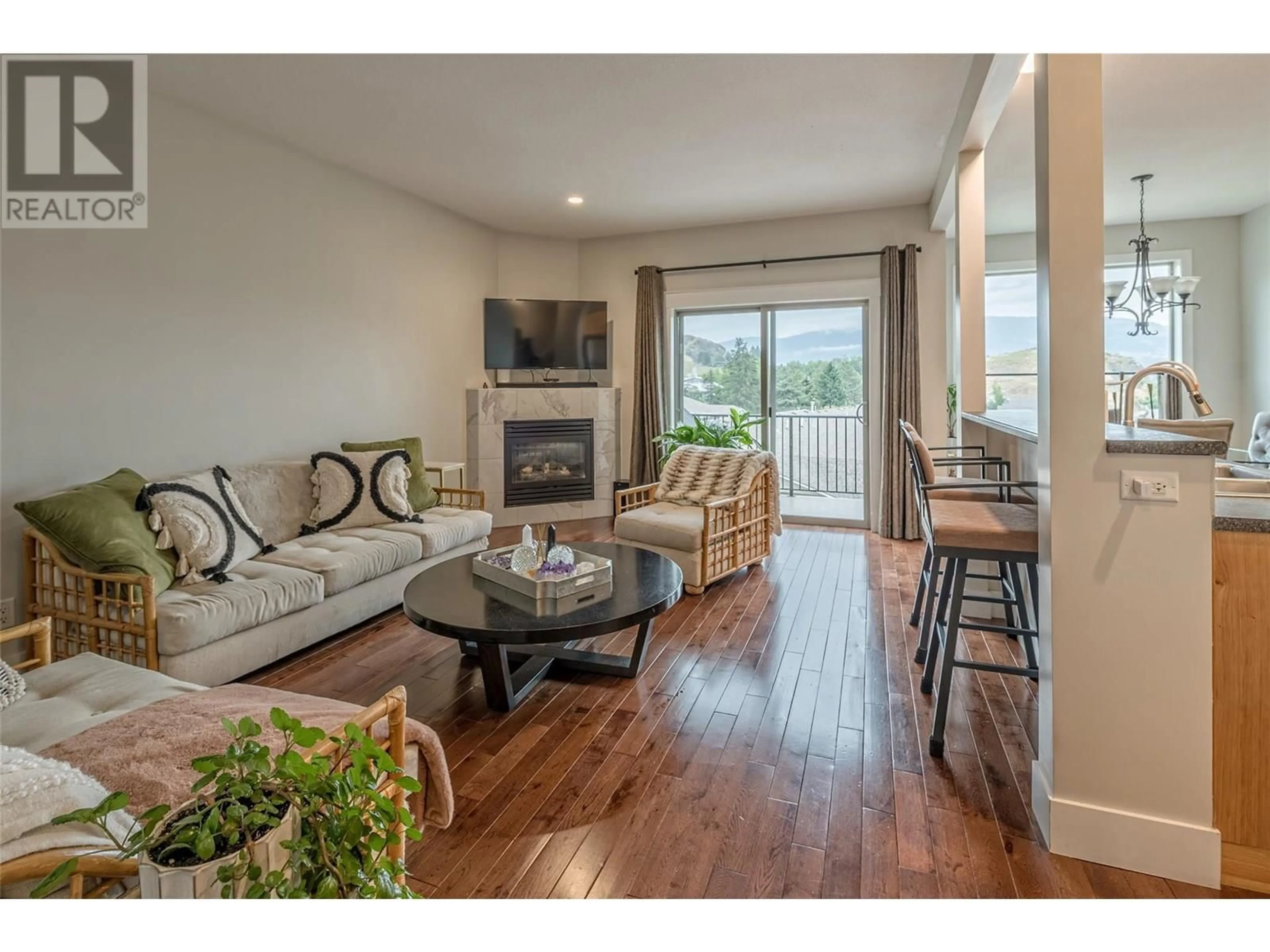 Living room with furniture, wood/laminate floor for 7 - 4724 HERITAGE DRIVE, Vernon British Columbia V1T7V4