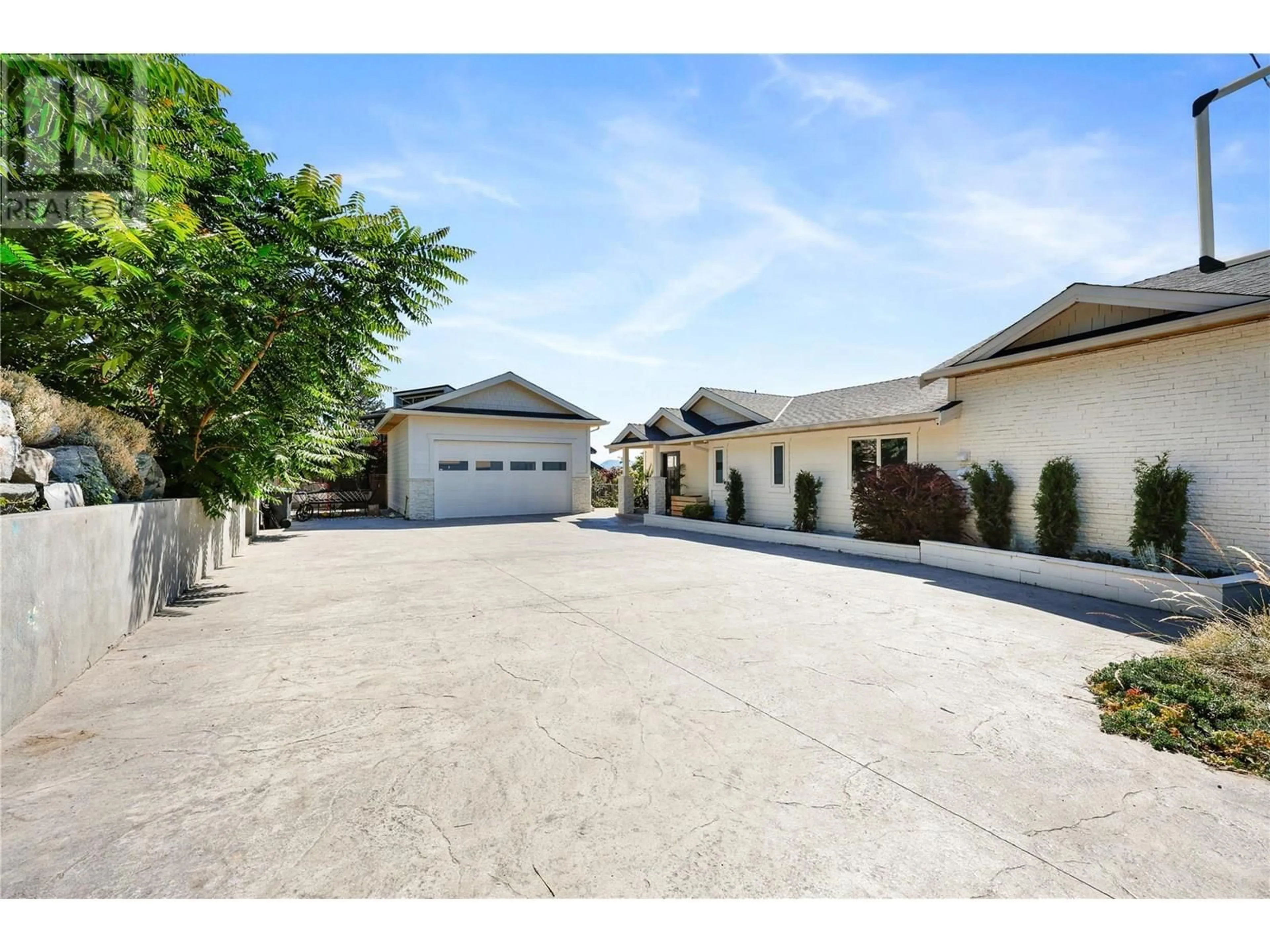 A pic from outside/outdoor area/front of a property/back of a property/a pic from drone, street for 1876 DEWDNEY ROAD, Kelowna British Columbia V1V2C3