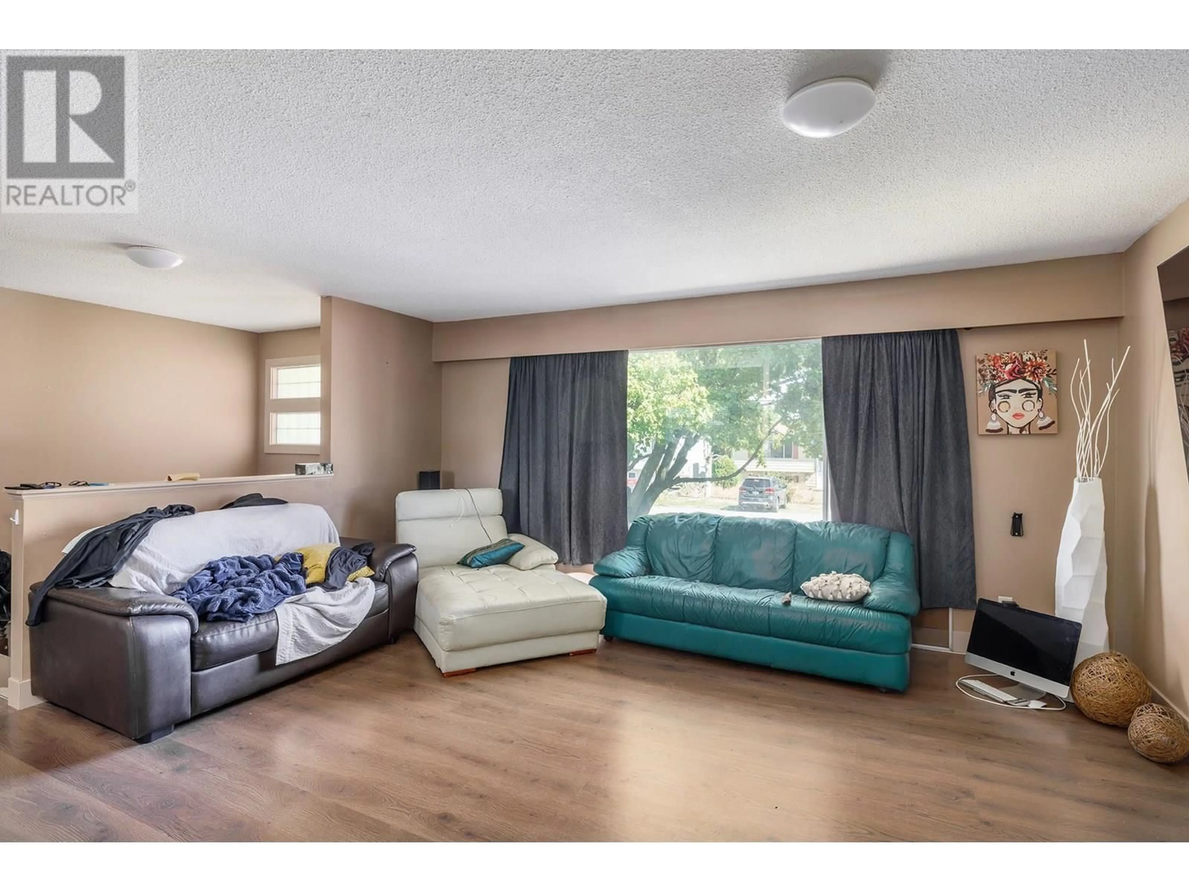 Living room with furniture, wood/laminate floor for 335 DUDGEON ROAD, Kelowna British Columbia V1X2L1