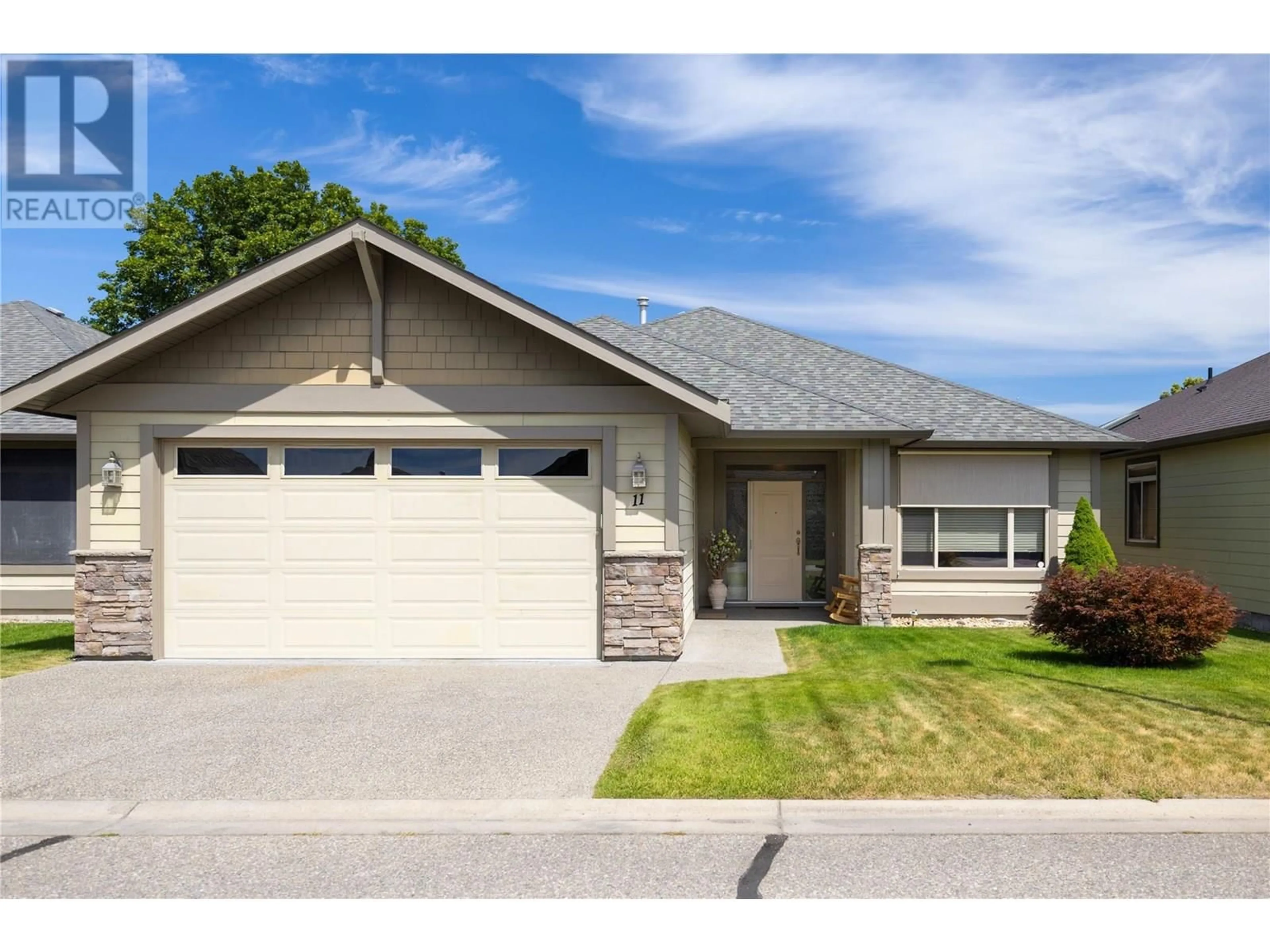 Home with vinyl exterior material, street for 11 - 6450 OKANAGAN LANDING ROAD, Vernon British Columbia V1H2H5