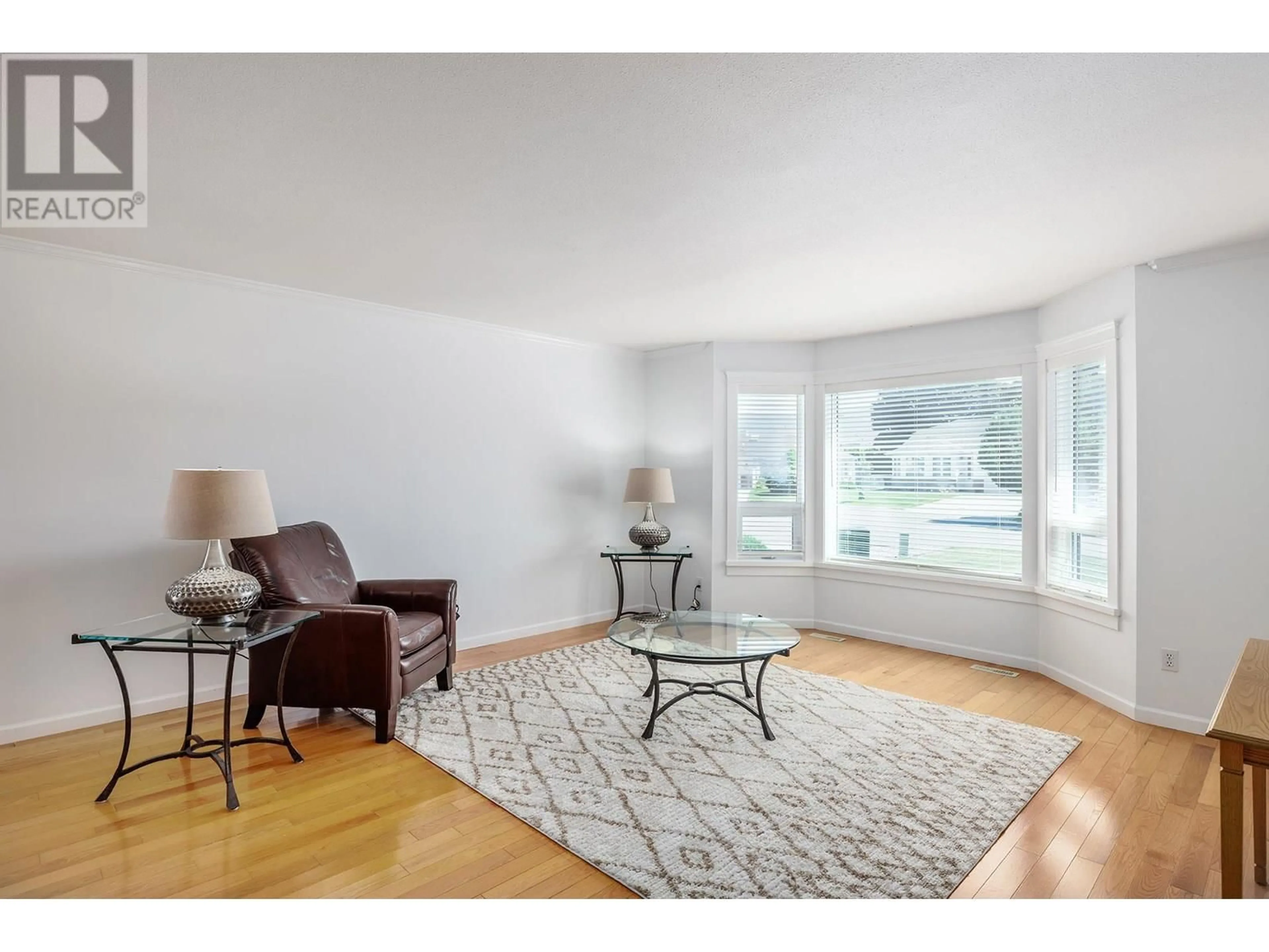 Living room with furniture, wood/laminate floor for 1470 NELSON PLACE, Kelowna British Columbia V1Y9H5