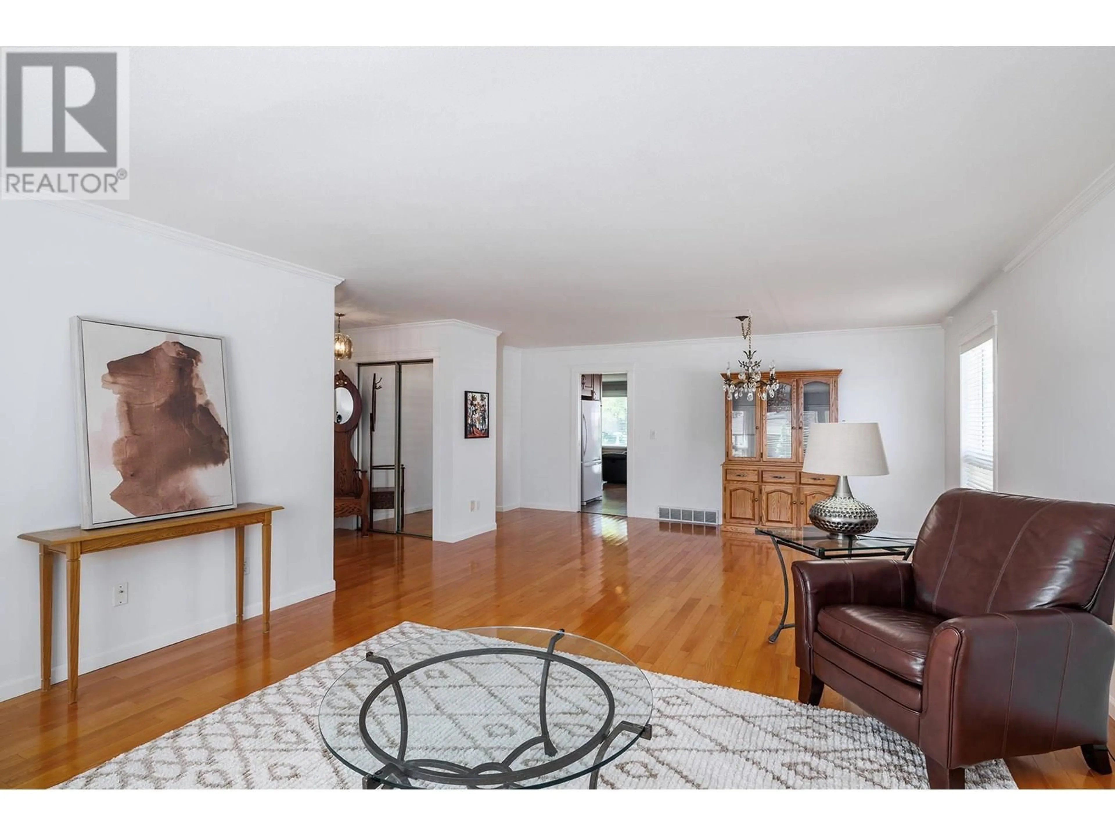 Living room with furniture, wood/laminate floor for 1470 NELSON PLACE, Kelowna British Columbia V1Y9H5