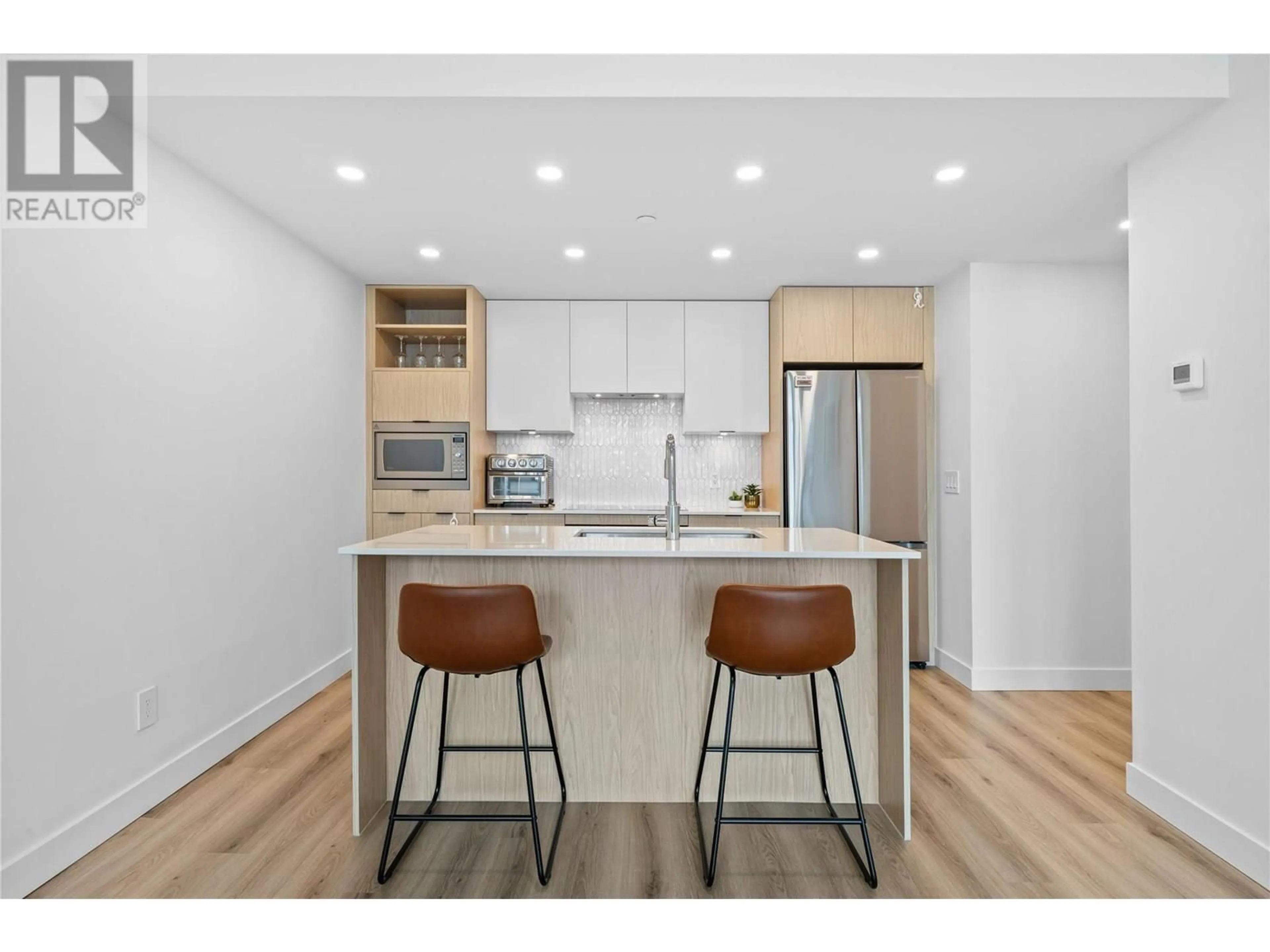 Open concept kitchen, wood/laminate floor for 3201 - 1488 BERTRAM STREET, Kelowna British Columbia V1Y0M6