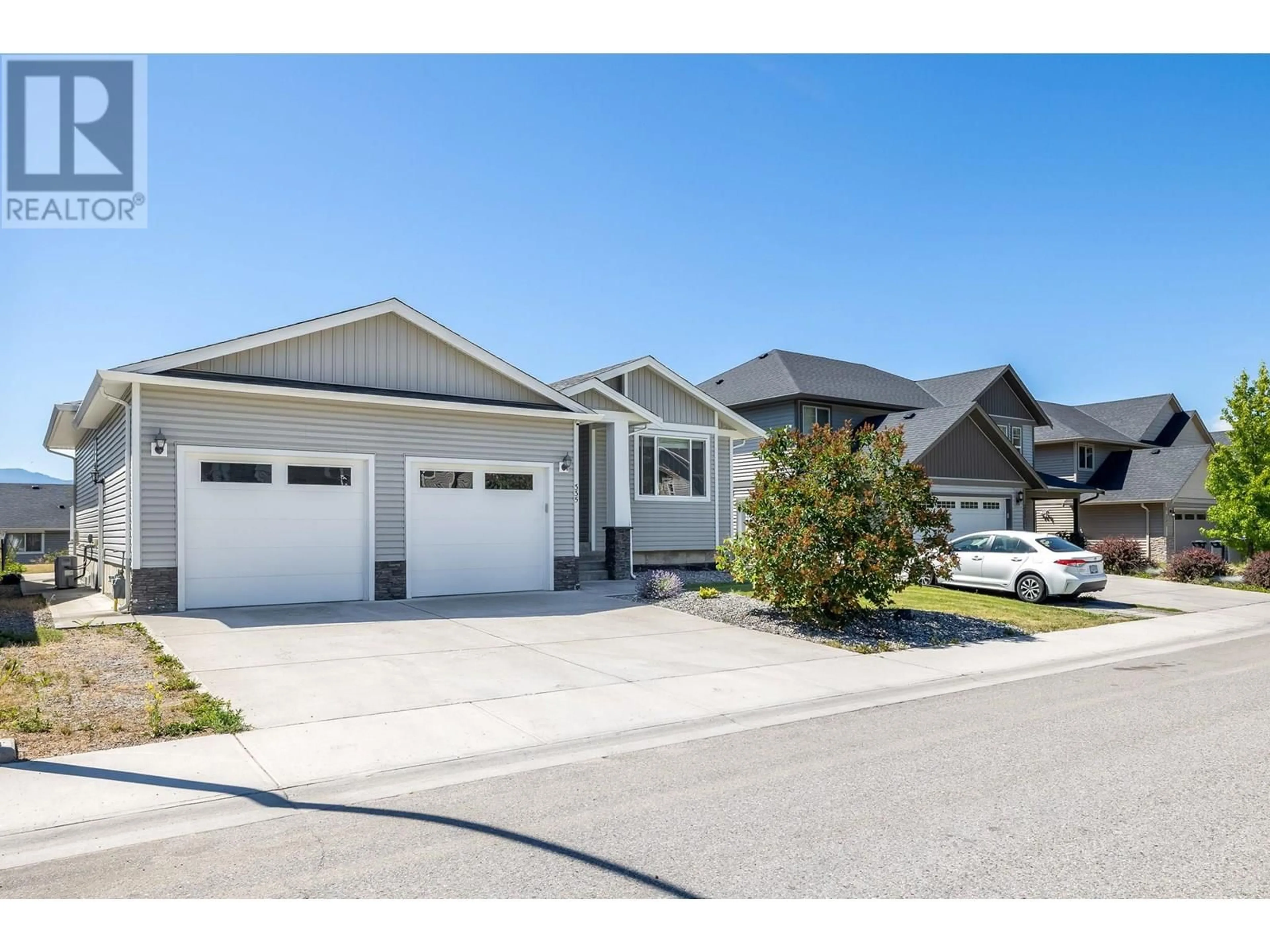 Home with vinyl exterior material, street for 335 ARAB ROAD, Kelowna British Columbia V1V3A8
