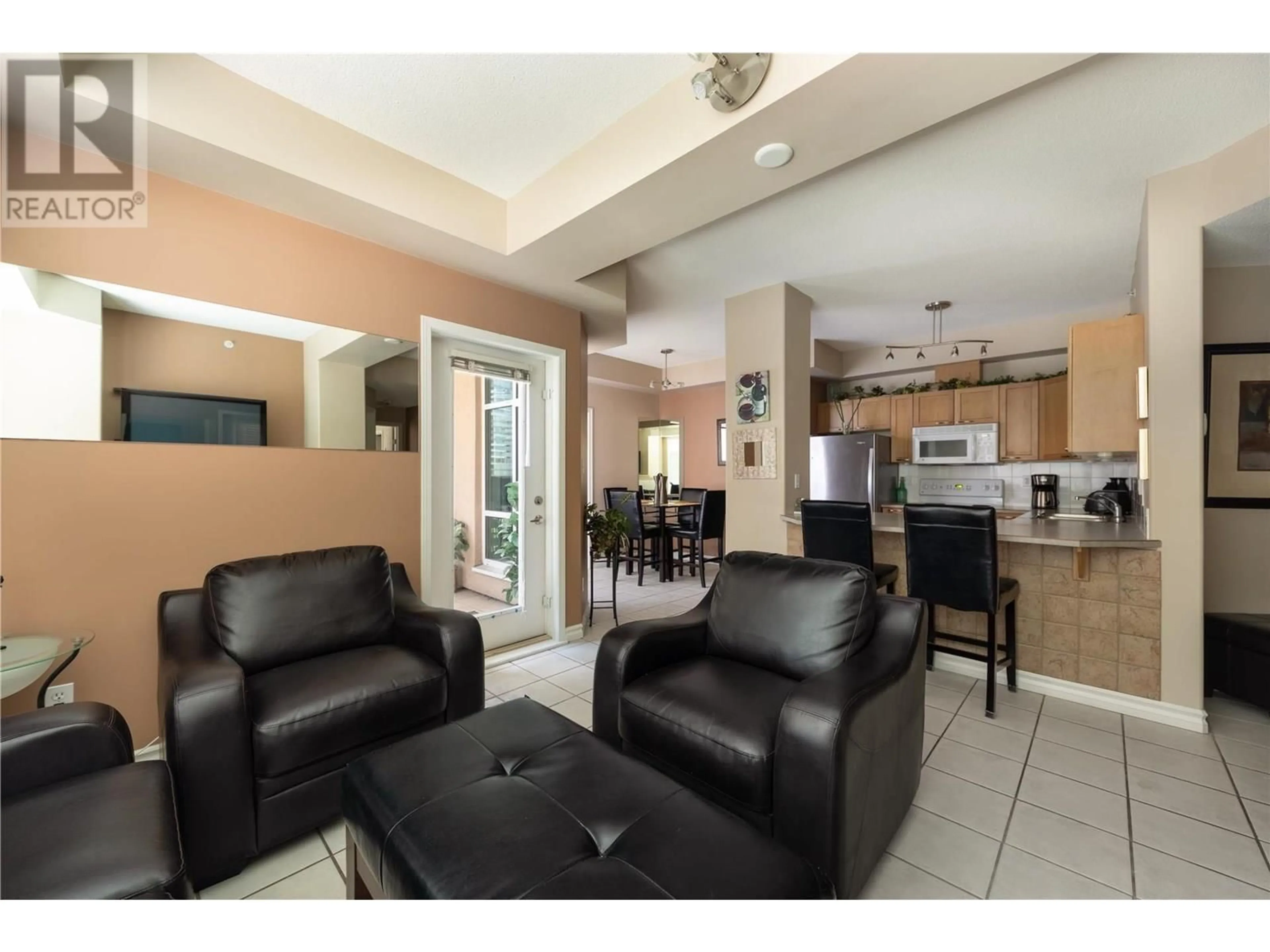 Living room with furniture, ceramic/tile floor for 1104 - 1128 SUNSET DRIVE, Kelowna British Columbia V1Y9W7
