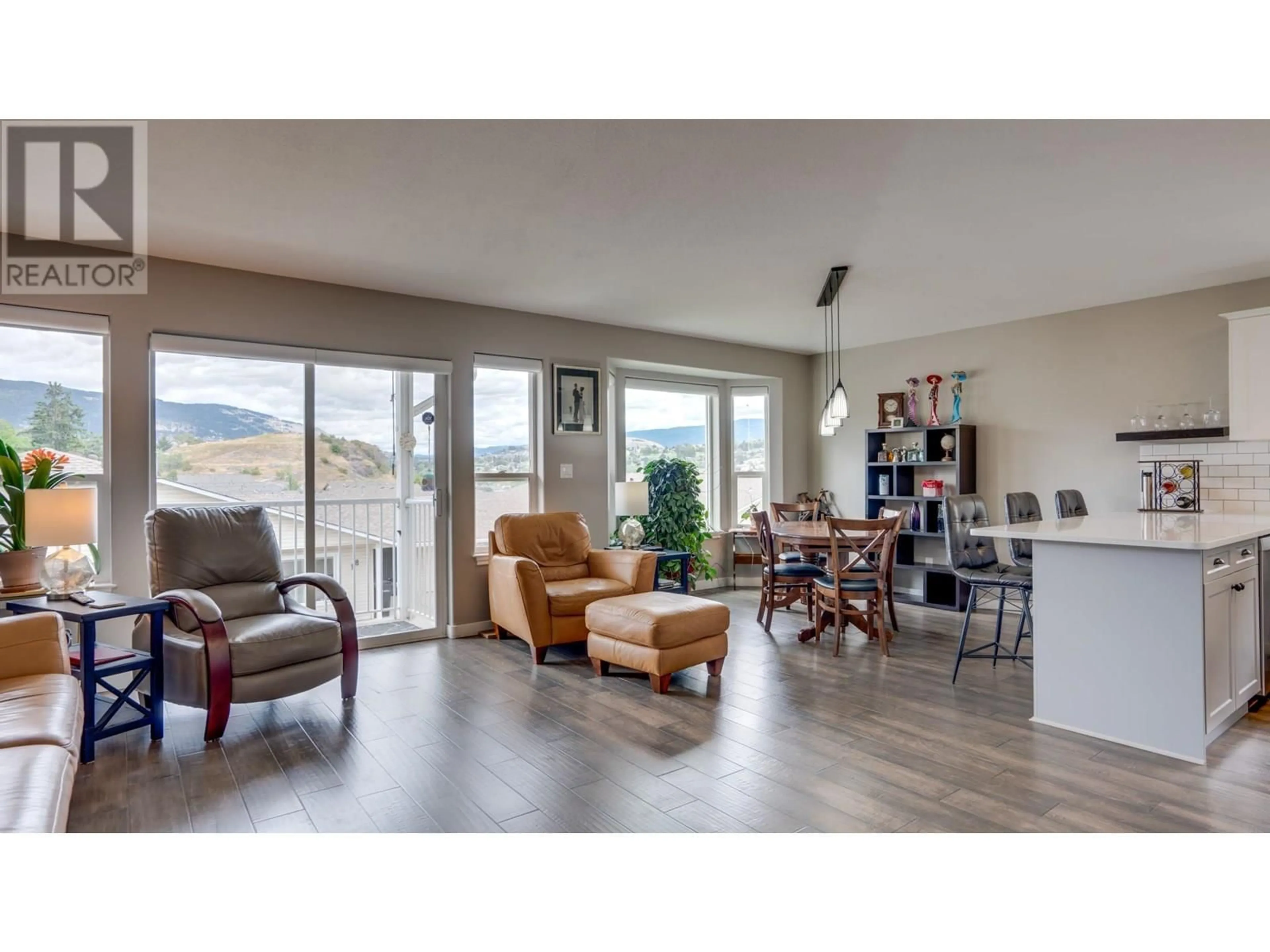 Living room with furniture, wood/laminate floor for 4 - 4700 BELLA VISTA ROAD, Vernon British Columbia V1T2N4