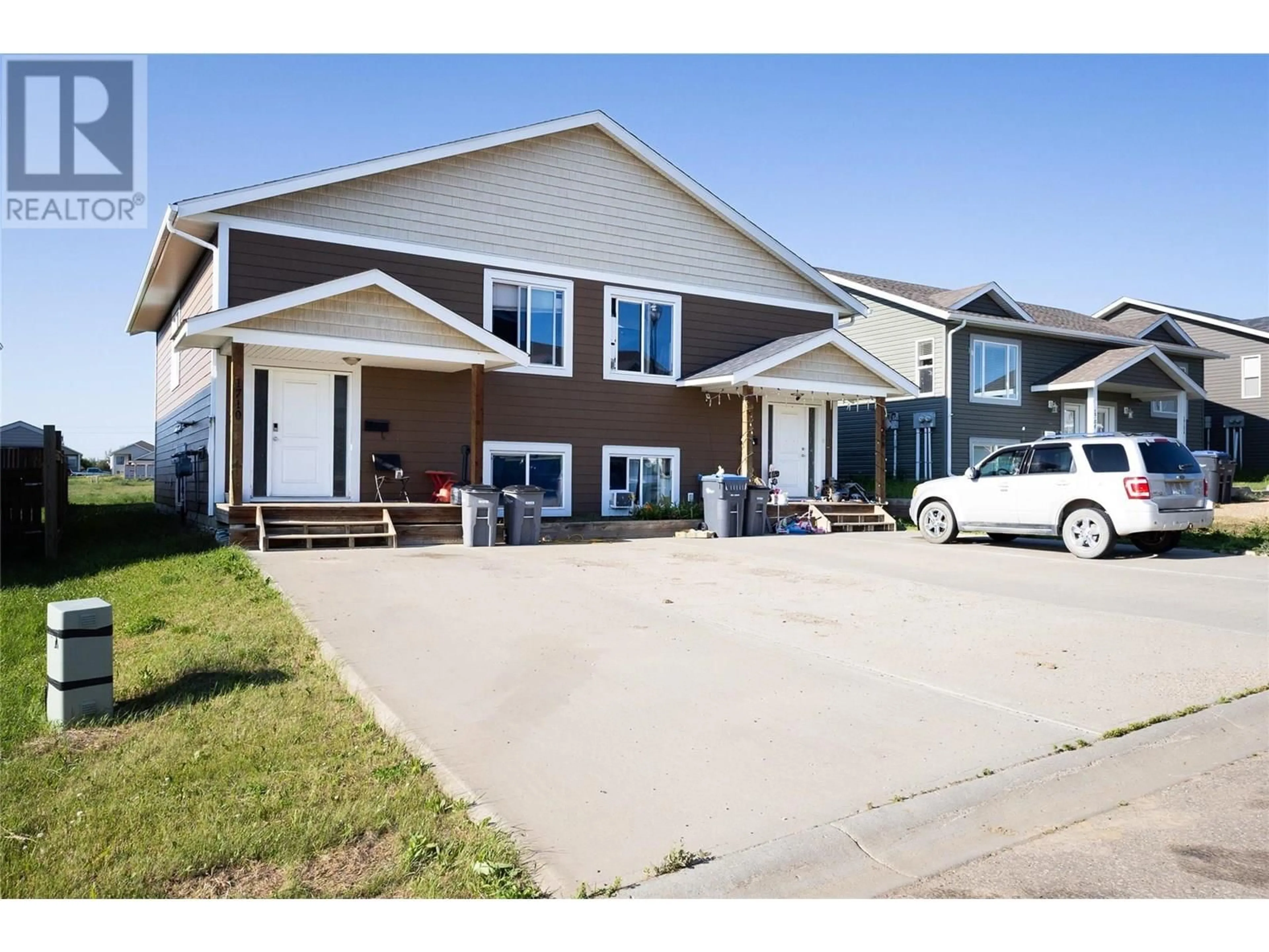 Home with vinyl exterior material, street for 1708 84 AVENUE, Dawson Creek British Columbia V1G3L5
