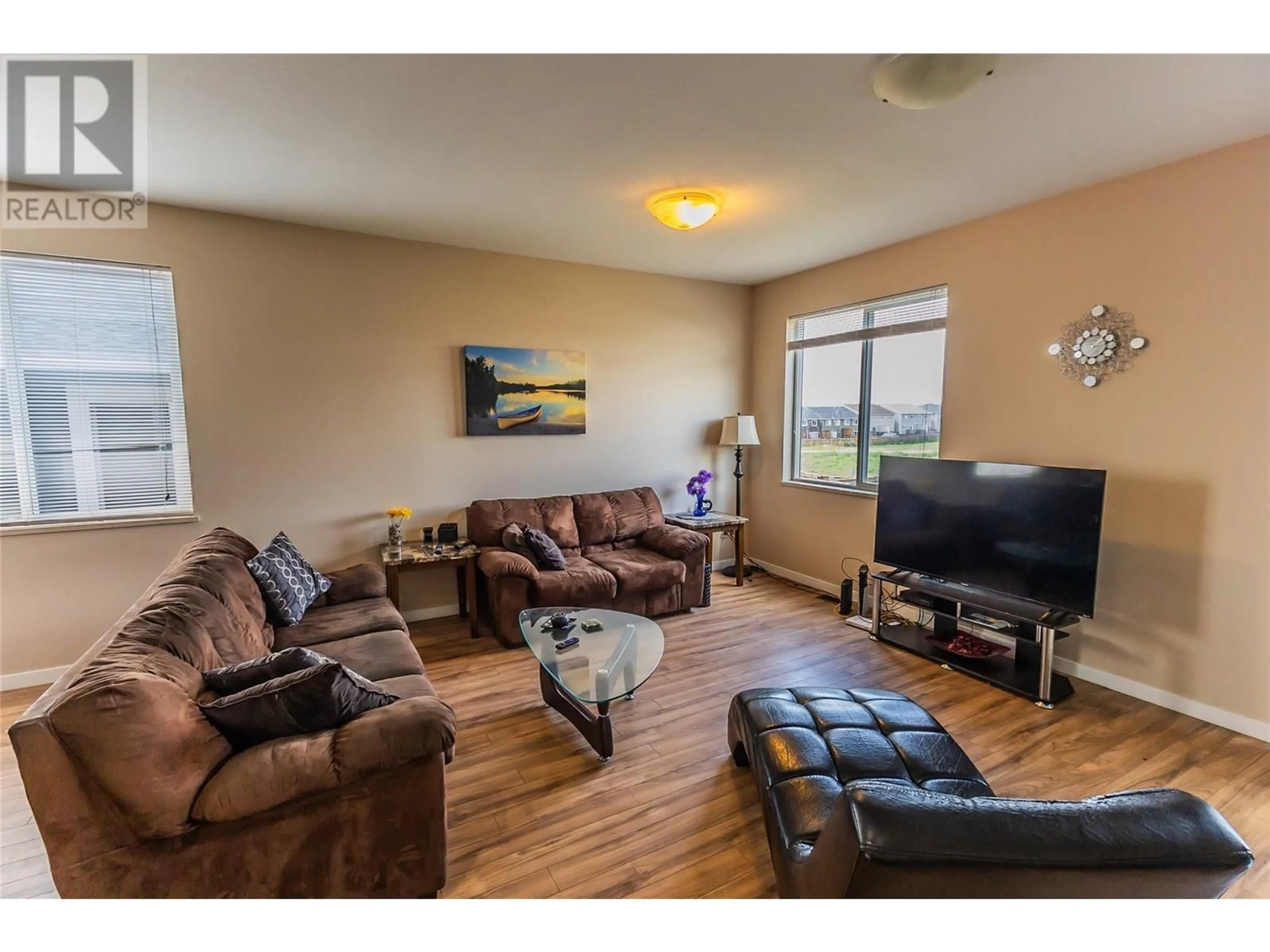 Living room with furniture, wood/laminate floor for 1708 84 AVENUE, Dawson Creek British Columbia V1G3L5