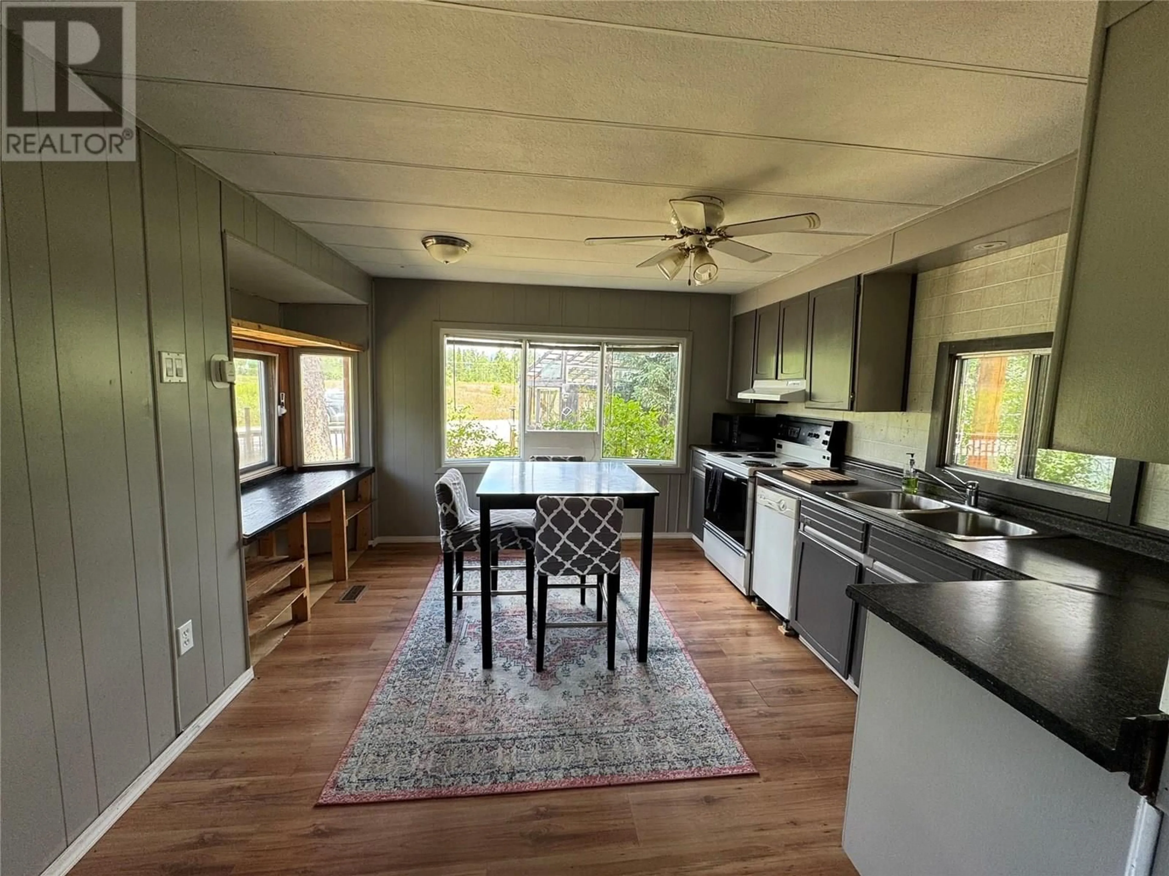 Open concept kitchen, wood/laminate floor for 5922 STEWART STREET, Blue River British Columbia V0J1J0
