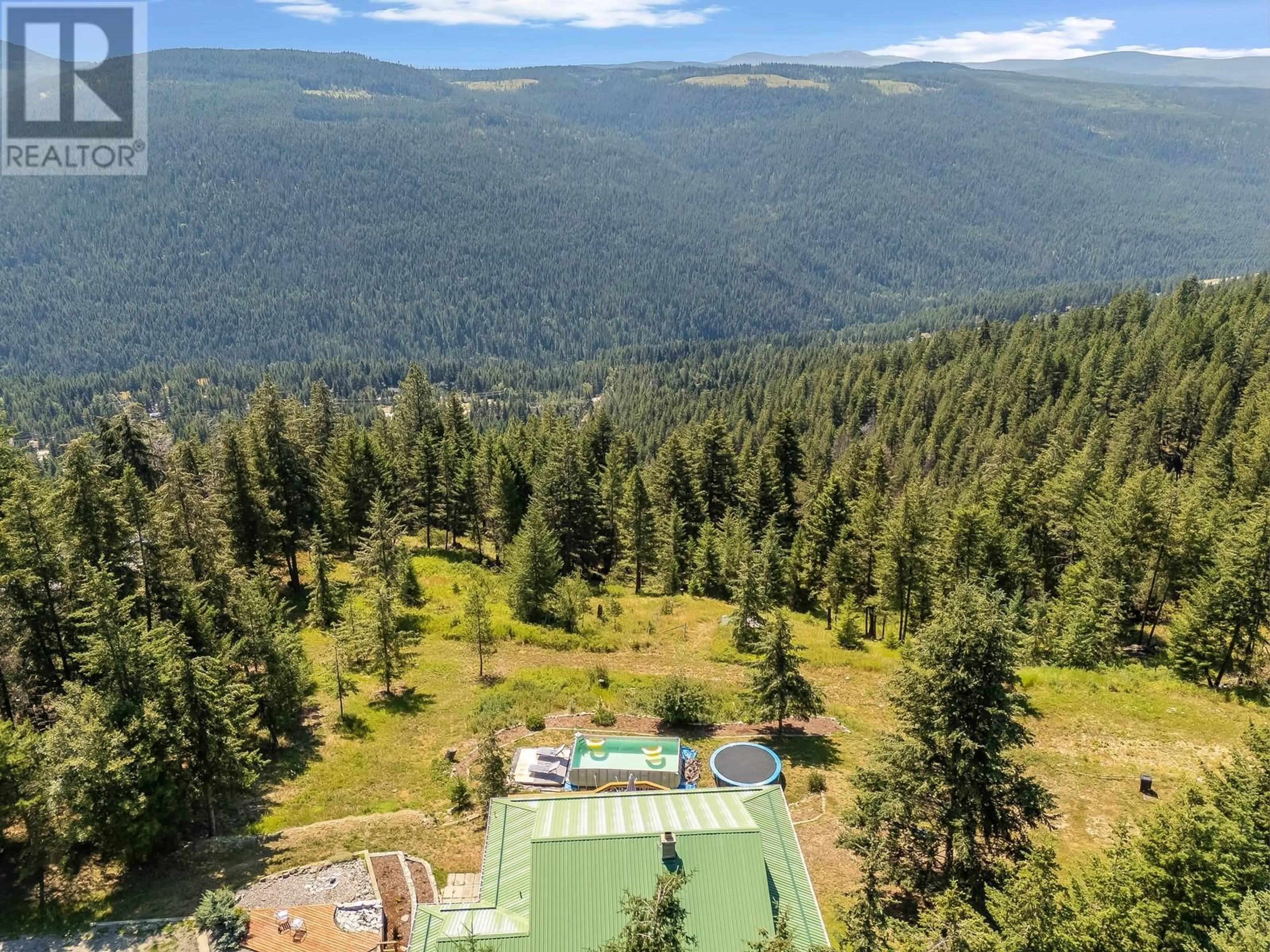 A pic from outside/outdoor area/front of a property/back of a property/a pic from drone, forest/trees view for 7575 SUN VALLEY ROAD, Kelowna British Columbia V1P1H4
