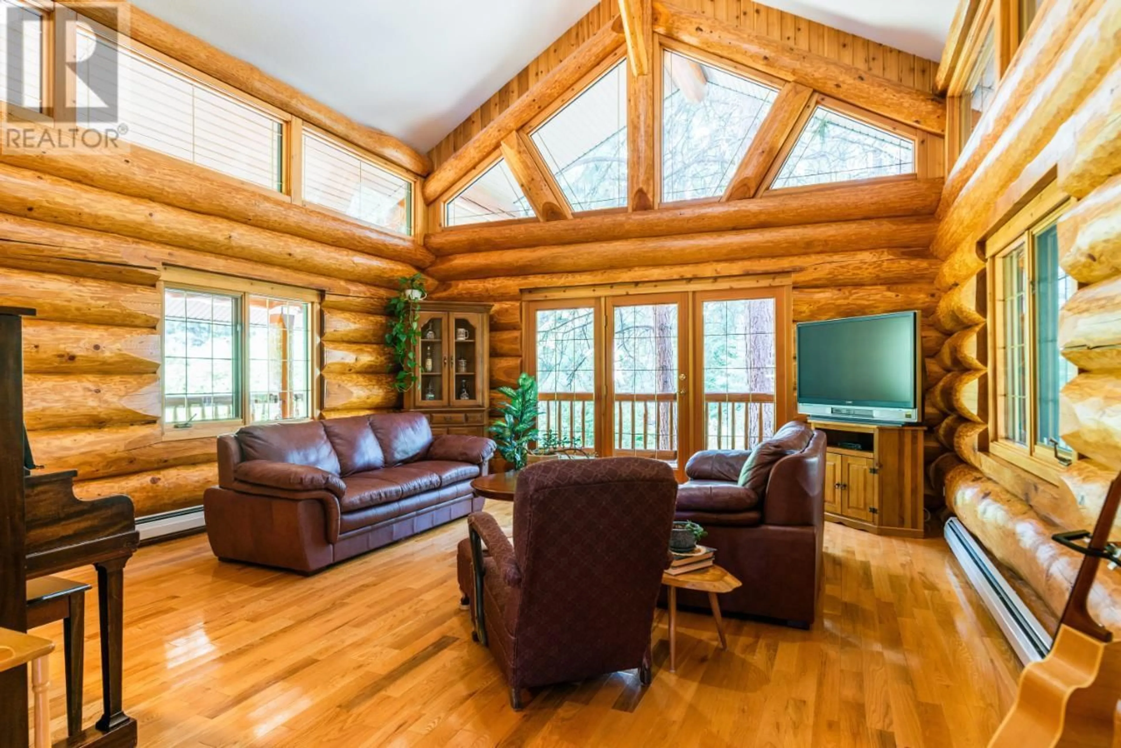 Living room with furniture, wood/laminate floor for 3150 HANNA CREEK ROAD, Warfield British Columbia V1R4L3