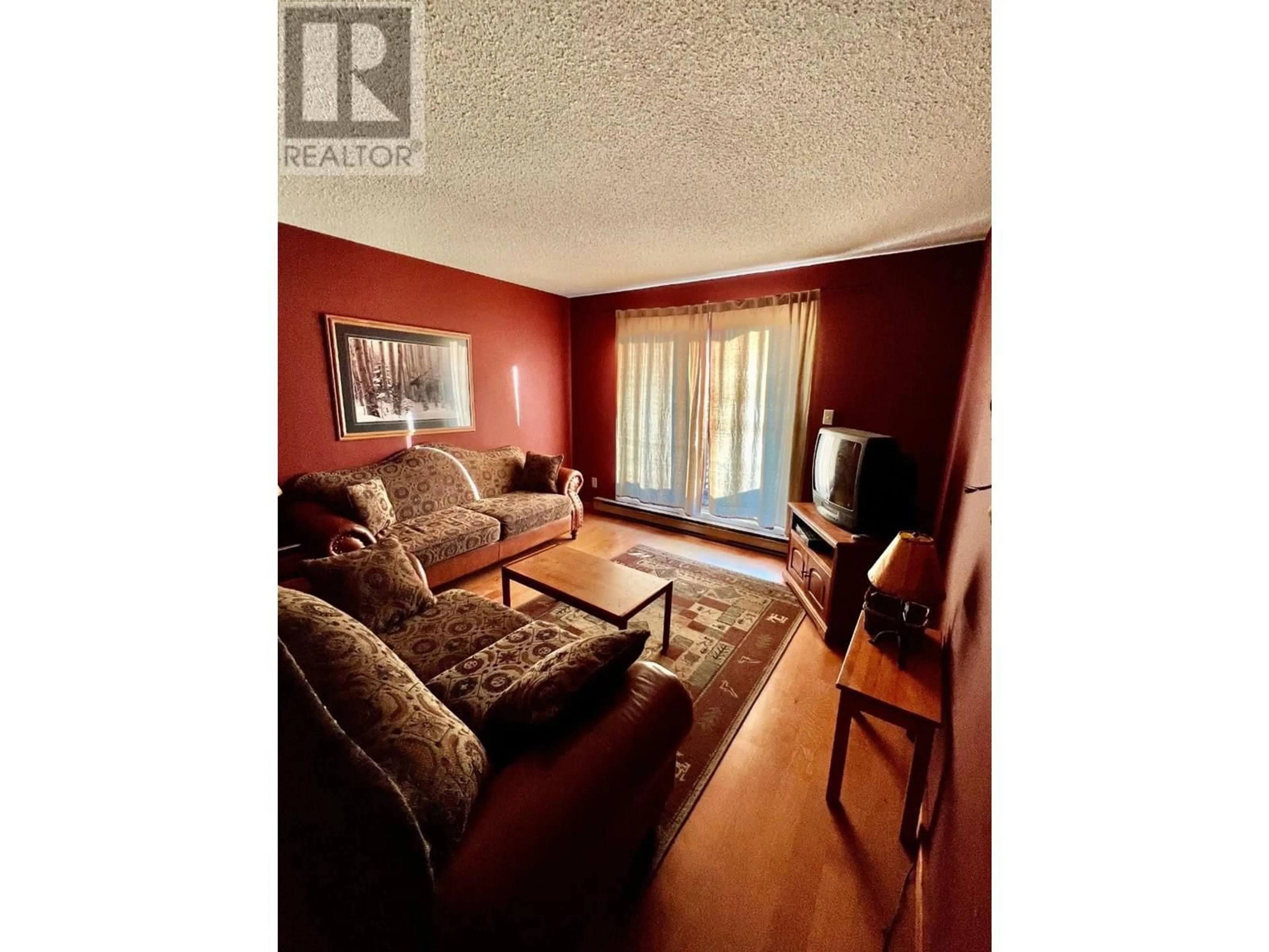 Living room with furniture, wood/laminate floor for 206 - 195 CHAMBERLAIN CRESCENT, Tumbler Ridge British Columbia V0C2W0