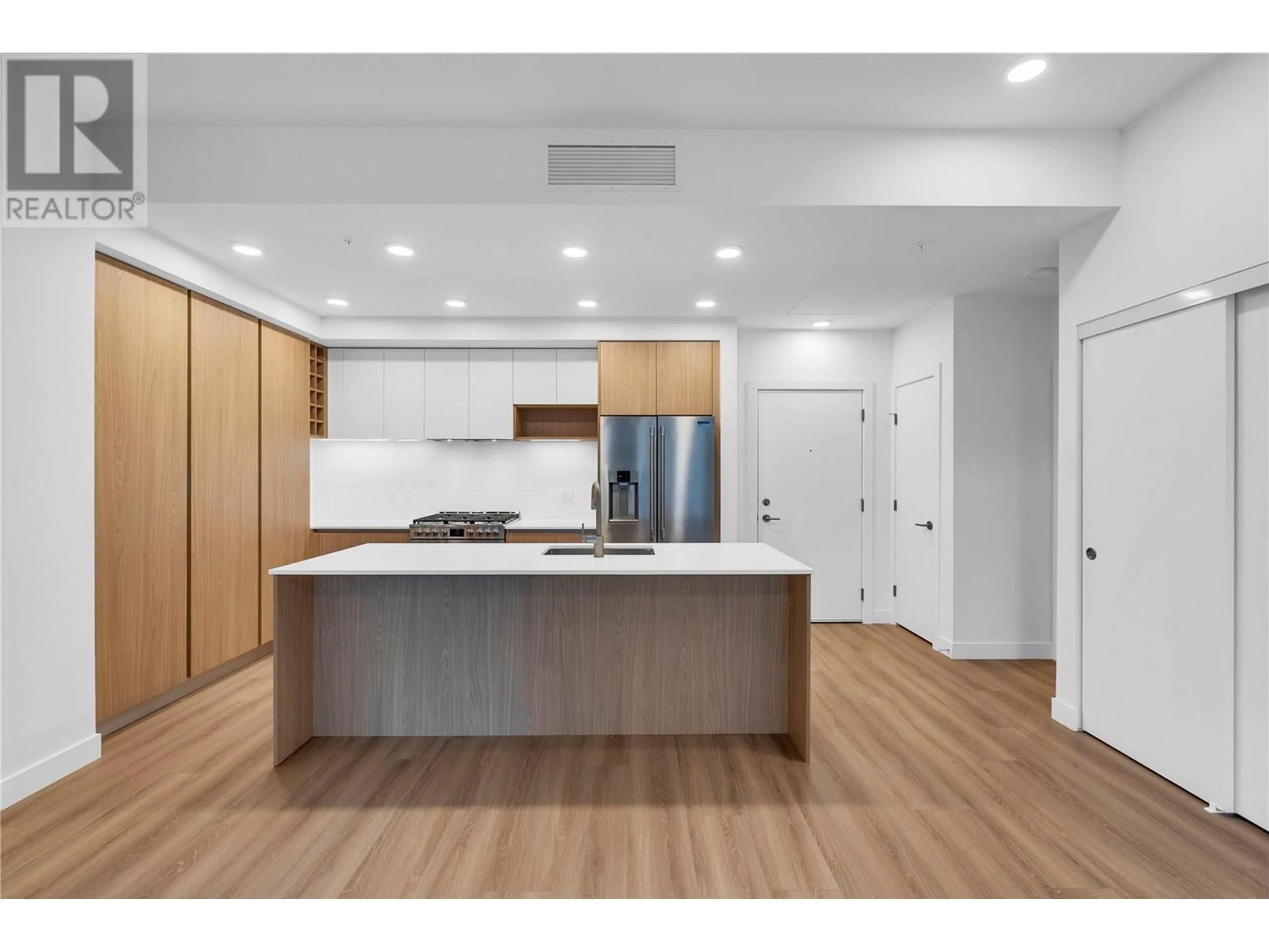 Open concept kitchen, wood/laminate floor for 202 - 2780 OLALLA ROAD, West Kelowna British Columbia V1Z2A9