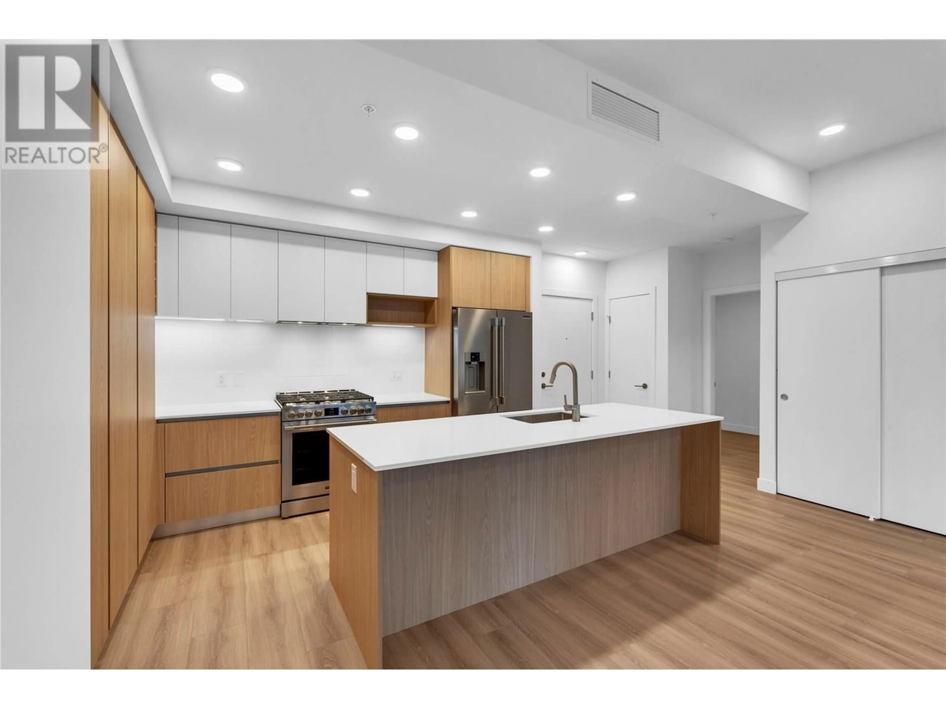 Open concept kitchen, wood/laminate floor for 202 - 2780 OLALLA ROAD, West Kelowna British Columbia V1Z2A9