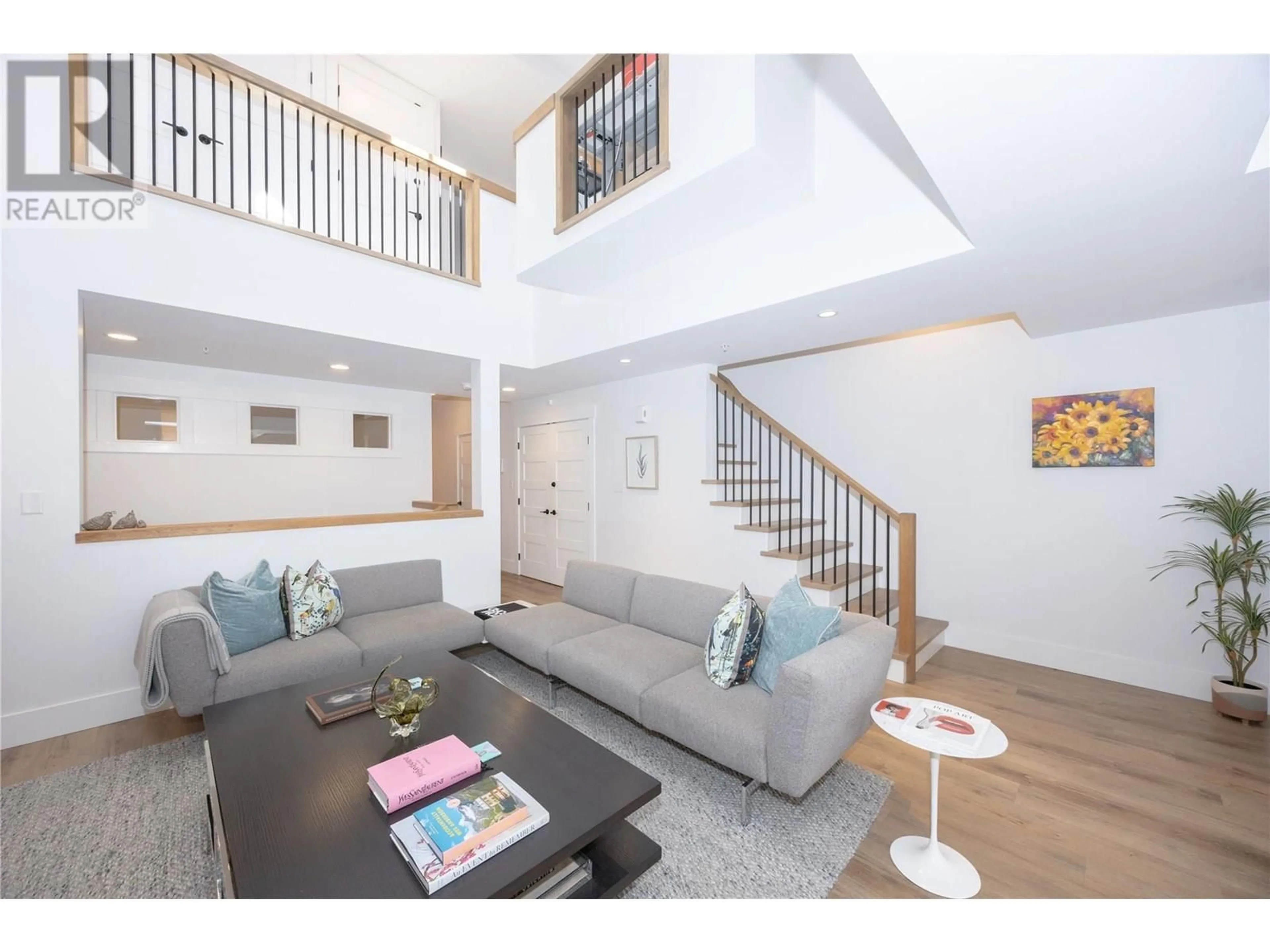 Living room with furniture, wood/laminate floor for 122 - 3880 TRUSWELL ROAD, Kelowna British Columbia V1W1A3