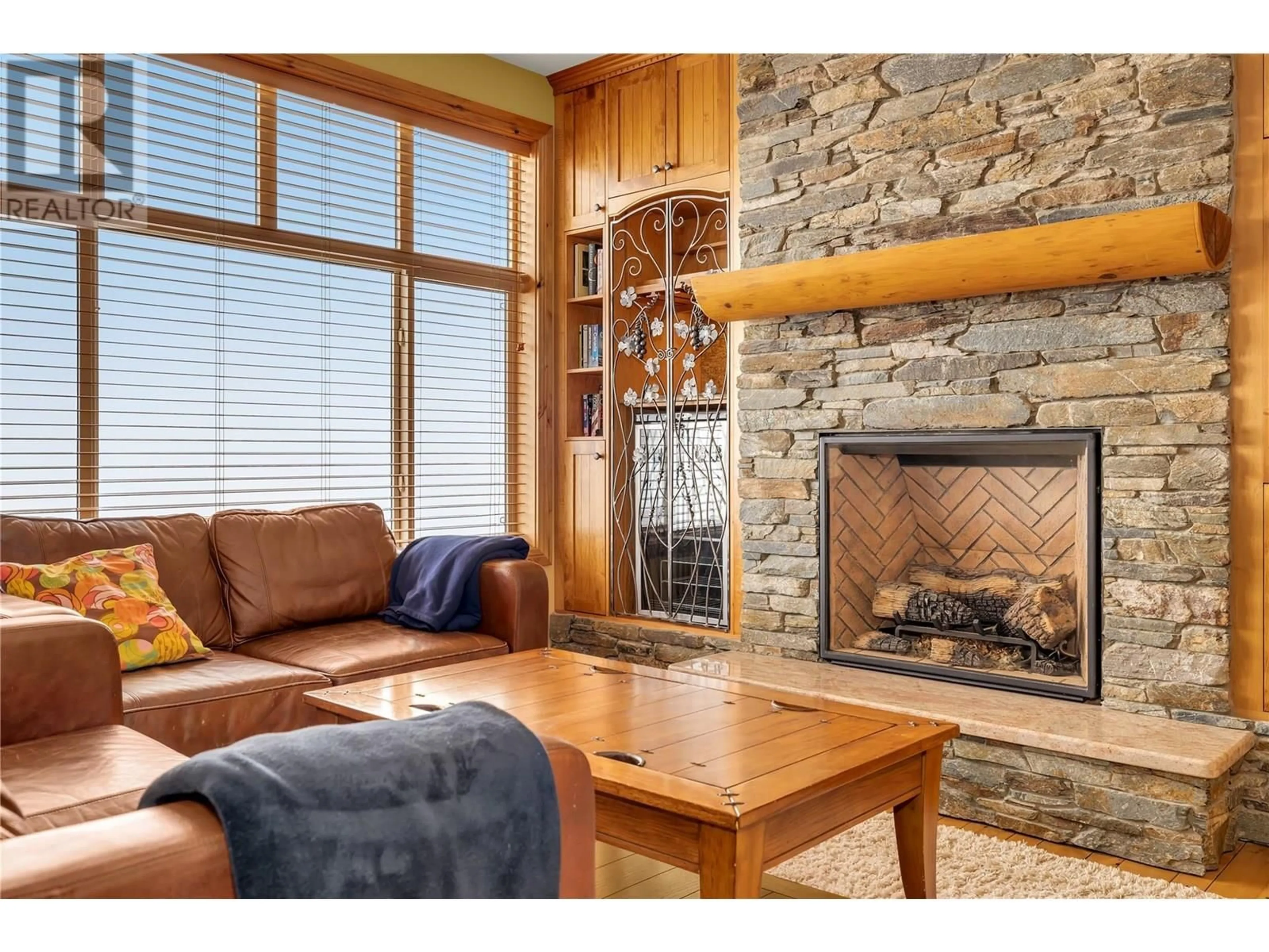 Living room with furniture, wood/laminate floor for 311 - 7700 PORCUPINE ROAD, Big White British Columbia V1P1P3