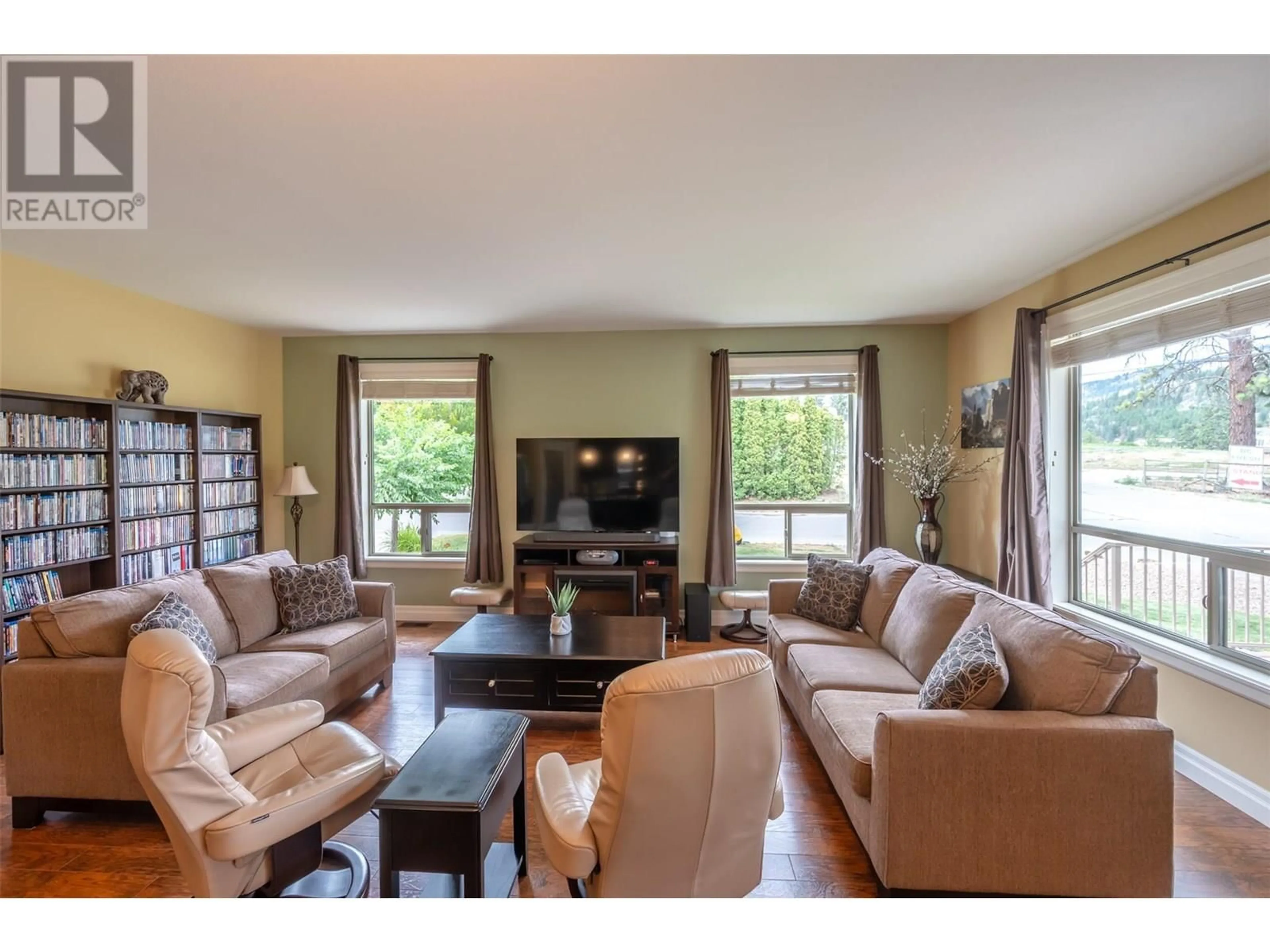 Living room with furniture, wood/laminate floor for 8641 PIERRE DRIVE, Summerland British Columbia V0H1Z2