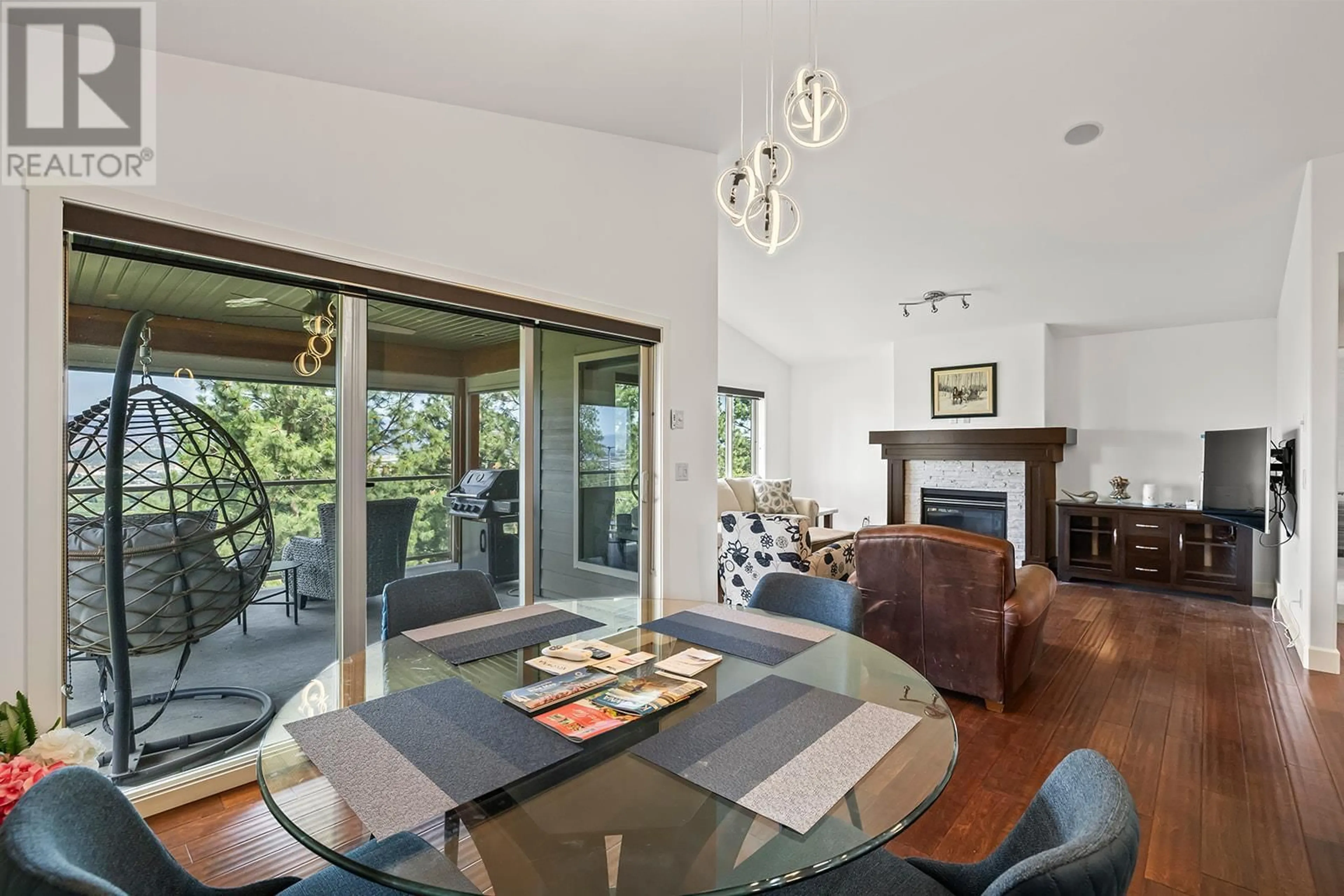 Living room with furniture, wood/laminate floor for 5318 TRICKLE CREEK DRIVE, Kelowna British Columbia V1X8C7