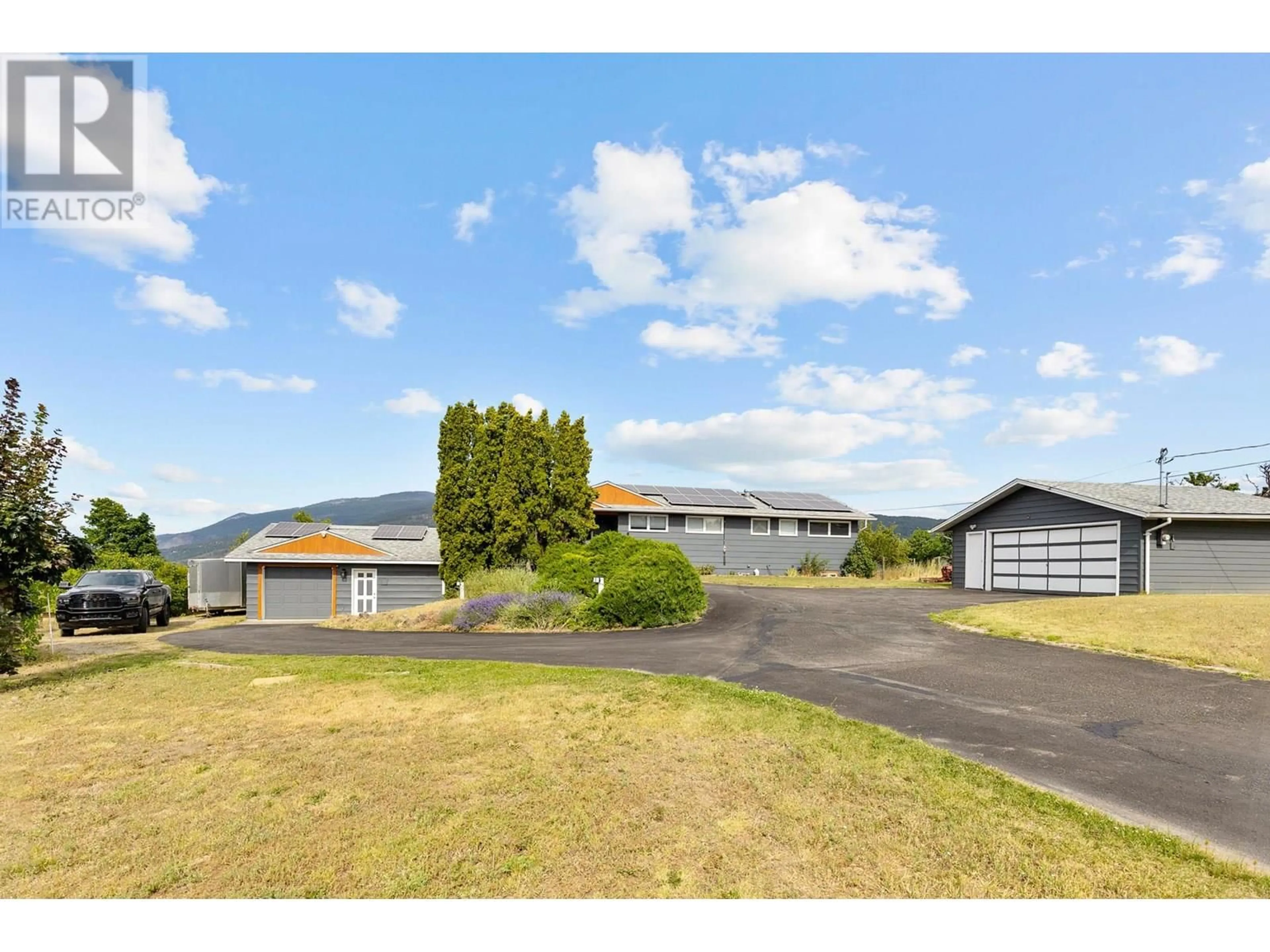 A pic from outside/outdoor area/front of a property/back of a property/a pic from drone, mountain view for 136 STEPPING STONES CRESCENT, Spallumcheen British Columbia V1H1X2