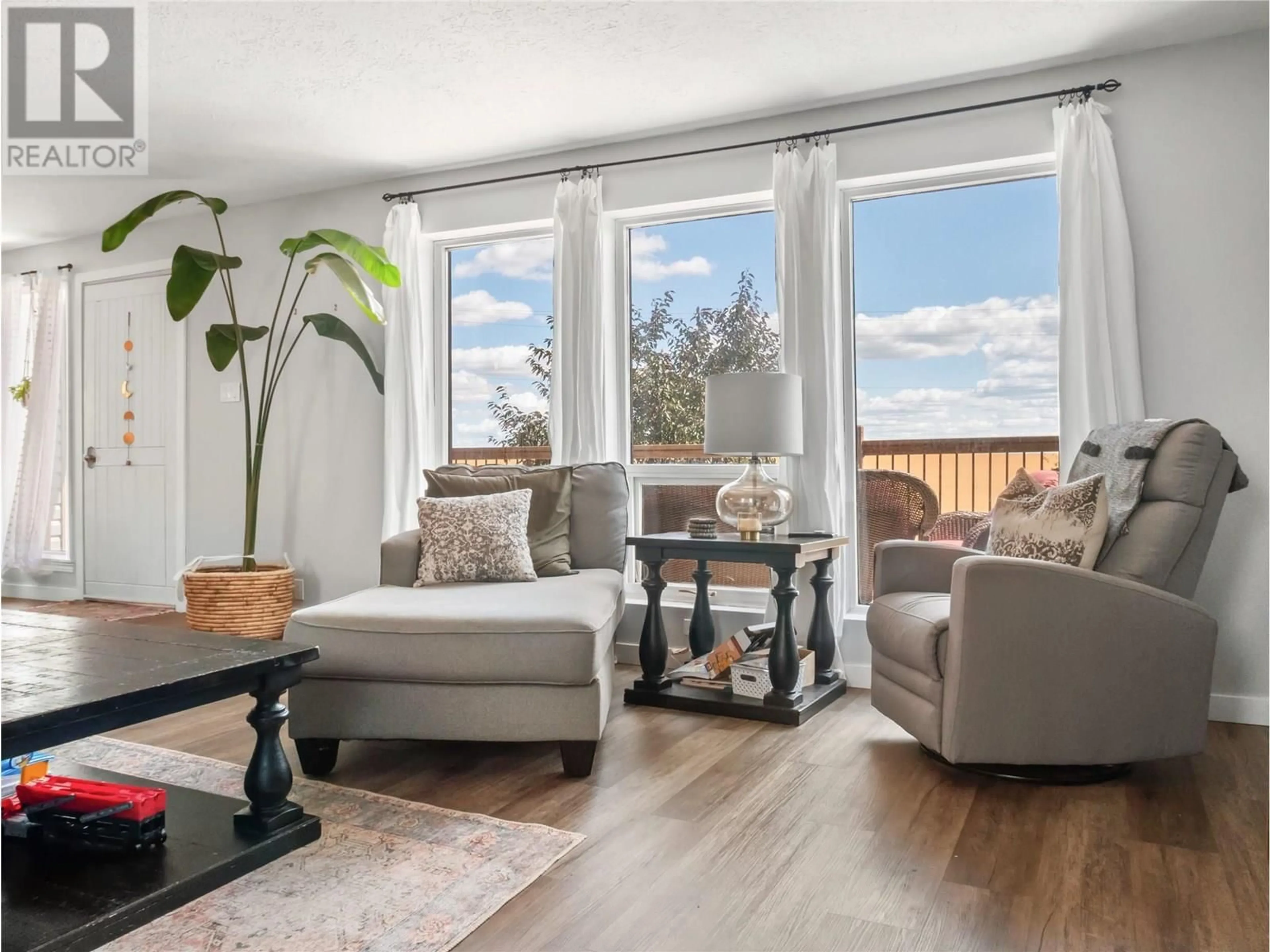 Living room with furniture, wood/laminate floor for 9913 2 STREET, Dawson Creek British Columbia V1G3L1
