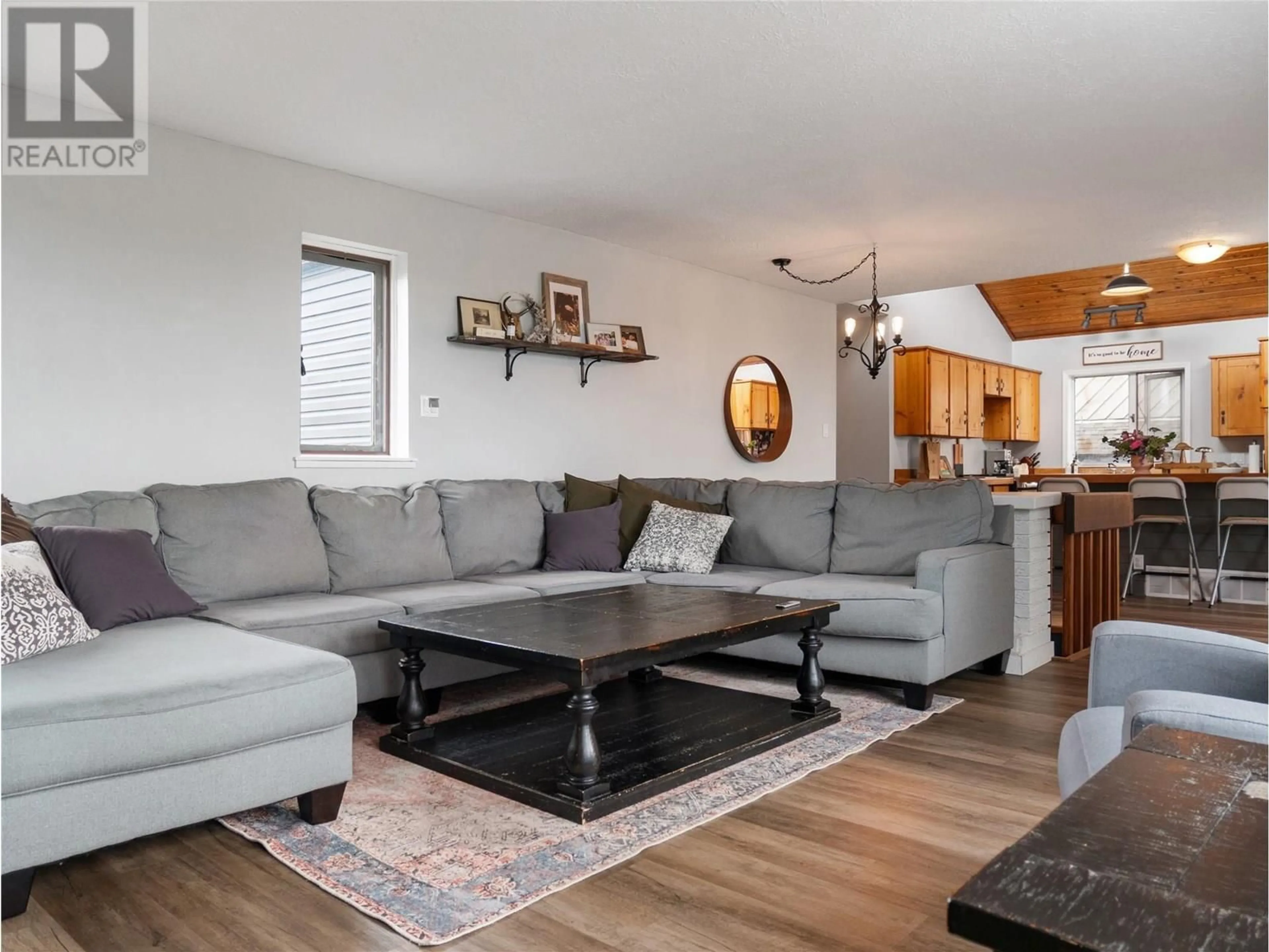 Living room with furniture, wood/laminate floor for 9913 2 STREET, Dawson Creek British Columbia V1G3L1