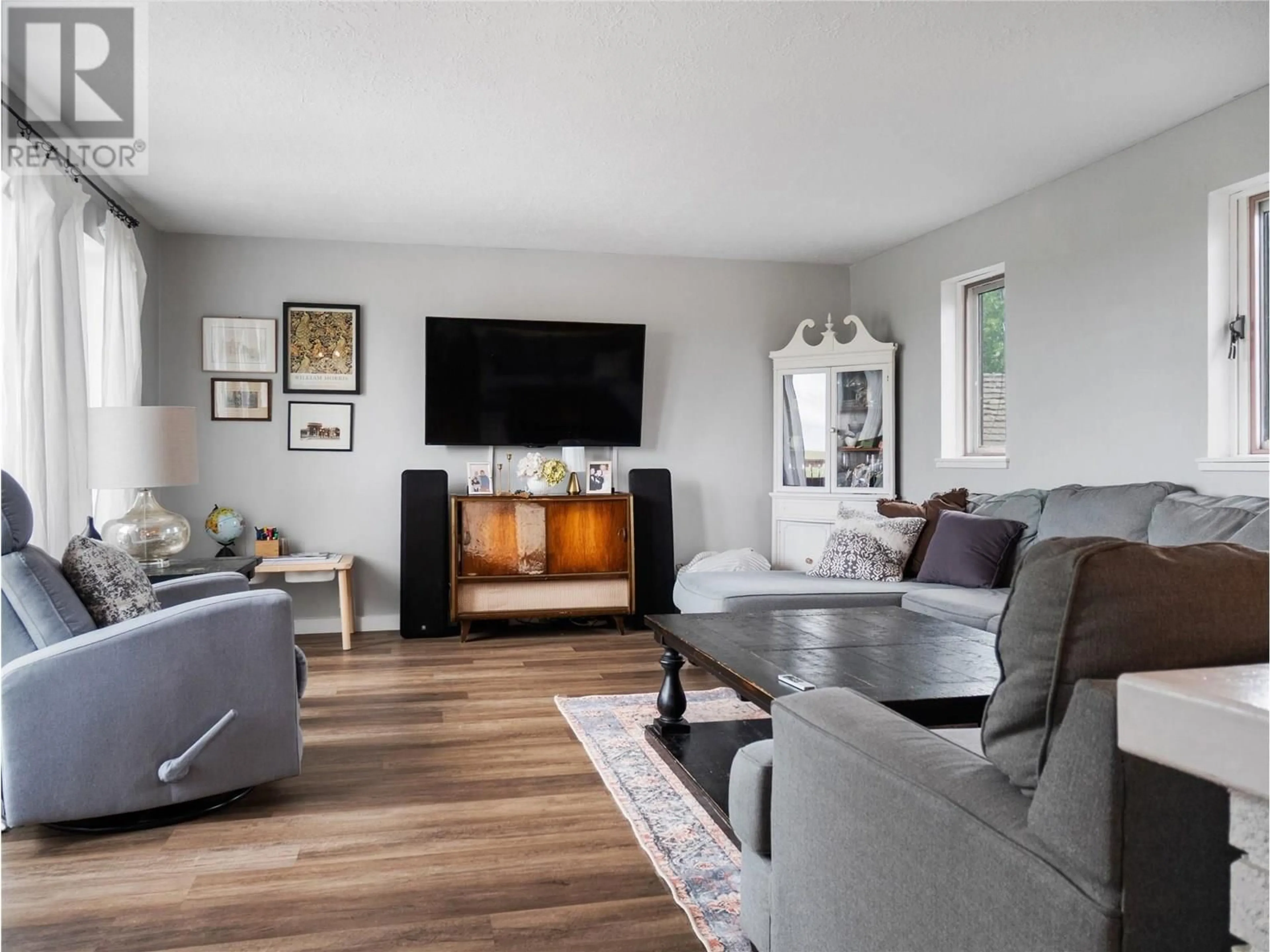 Living room with furniture, wood/laminate floor for 9913 2 STREET, Dawson Creek British Columbia V1G3L1
